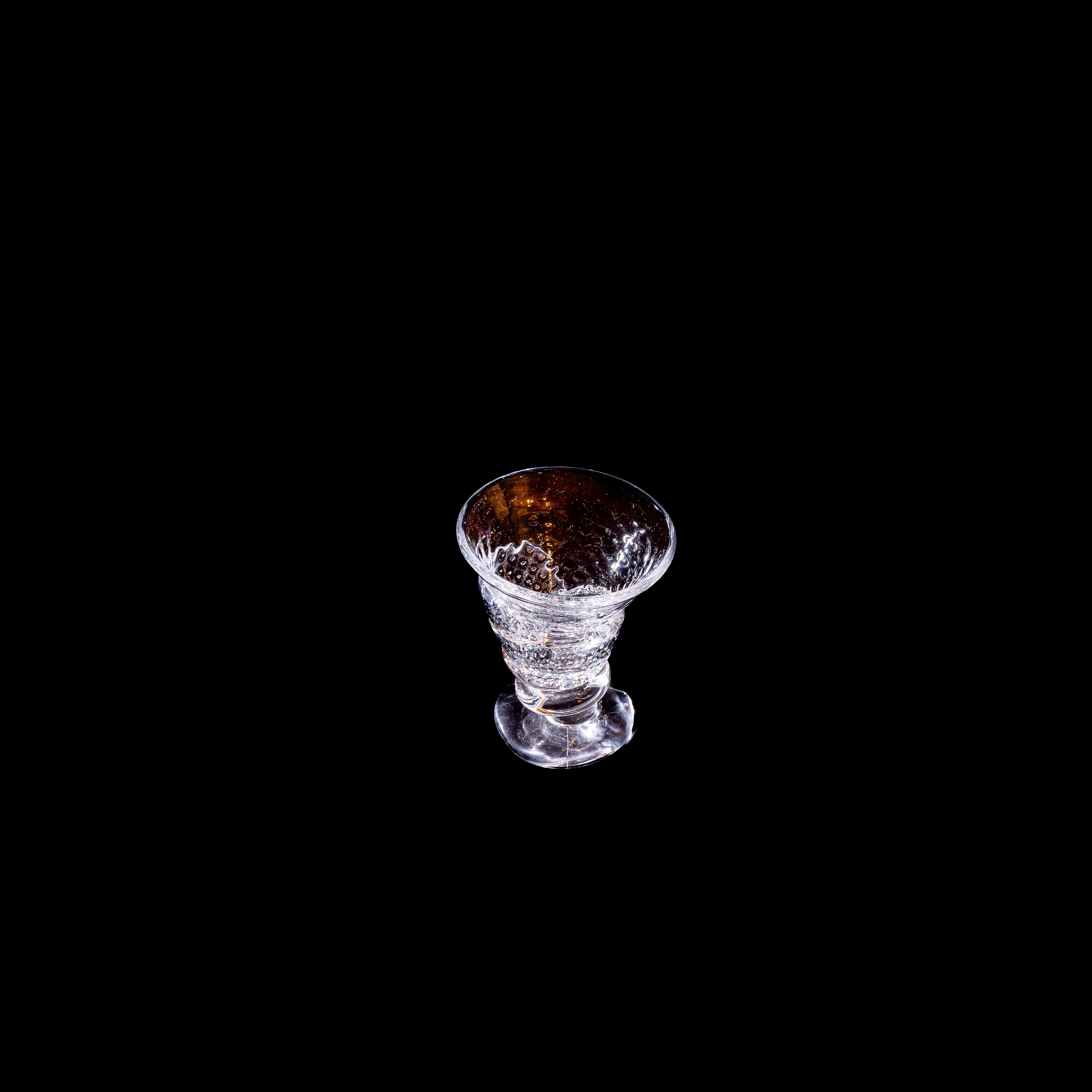 Blown Free-shaped Glass — top view on black background