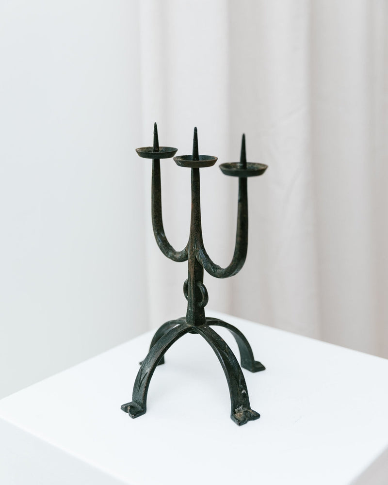 Iron Candleholder 70s — close-up of black iron design on pedestal
