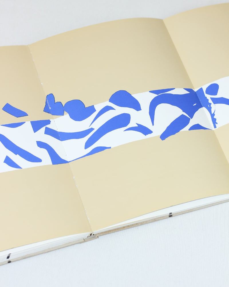 MATISSE PAPER CUTOUTS — close-up of blue paper cutouts on beige background