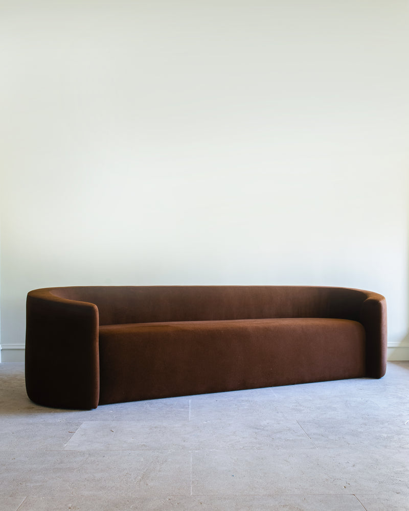 Brown velvet Trousdale sofa with curved minimalist design