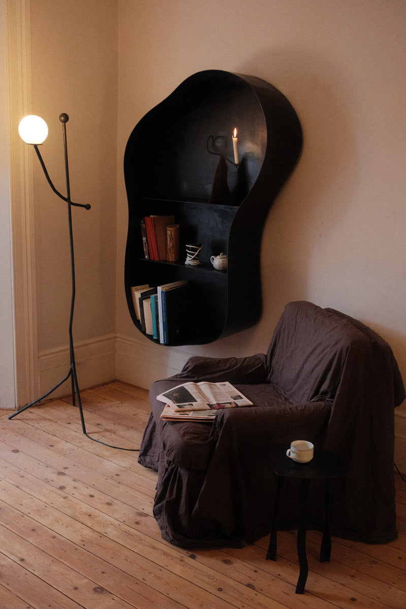 Large Metal Wall Shelf — angled view with books in cozy living room