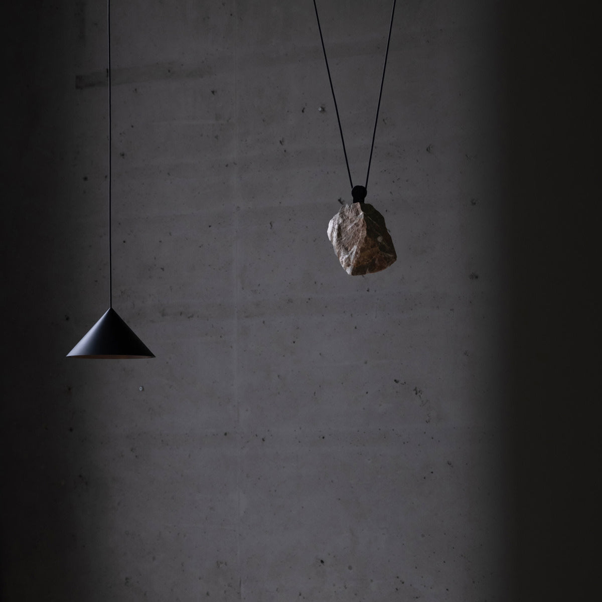 Pulse Light, single, dimmable lamp with a stone as a counterweight — lifestyle setting