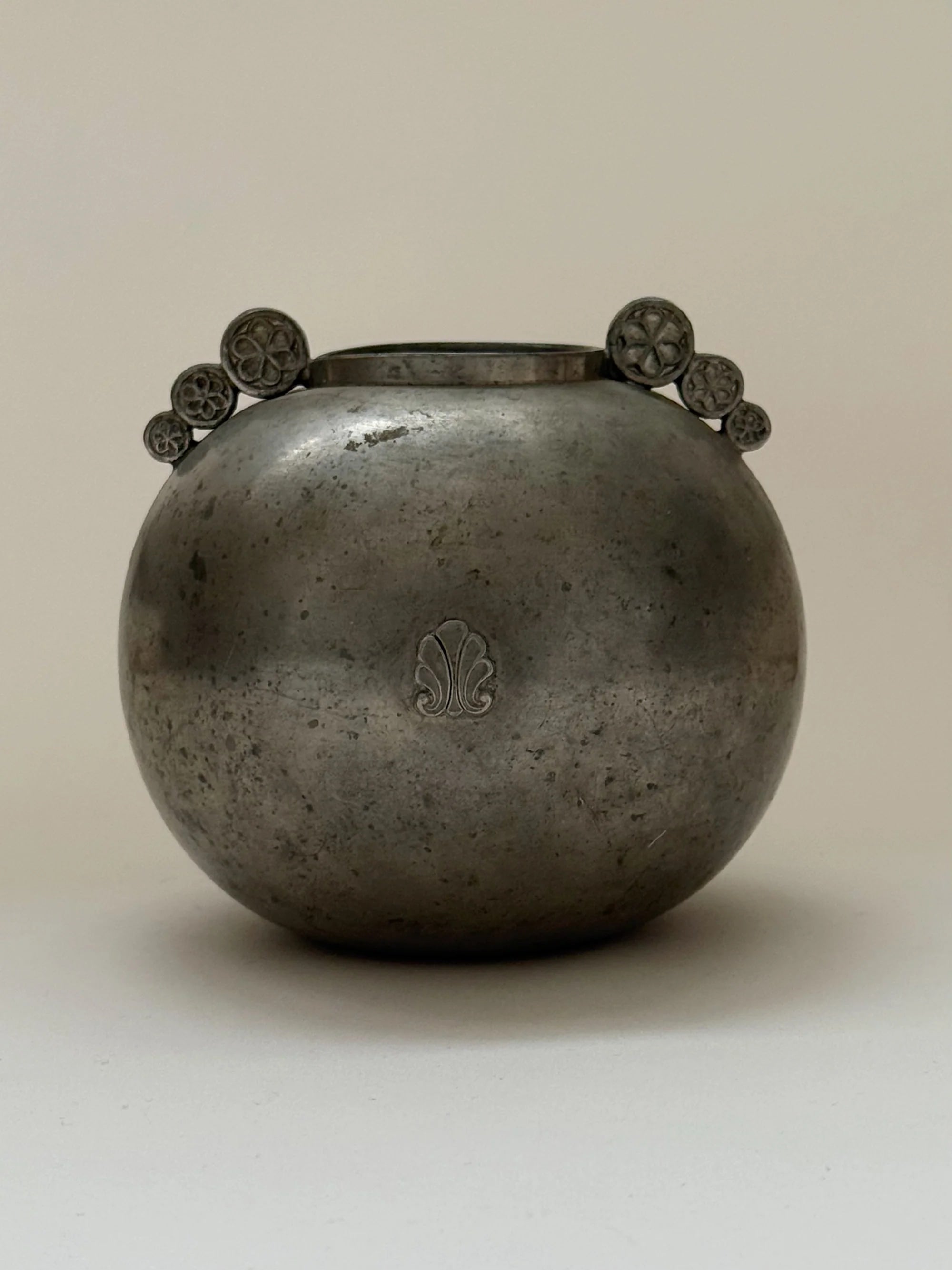 Swedish Grace Spherical Pewter Vase, 1934 — side angle showing decorative flower motifs
