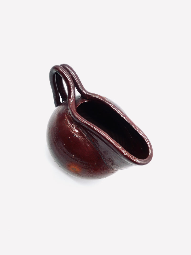 Dark burgundy terracotta jug showing spout and handle detail