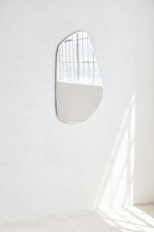 Geo Mirror in Polished Aluminum — mounted on white wall with natural light