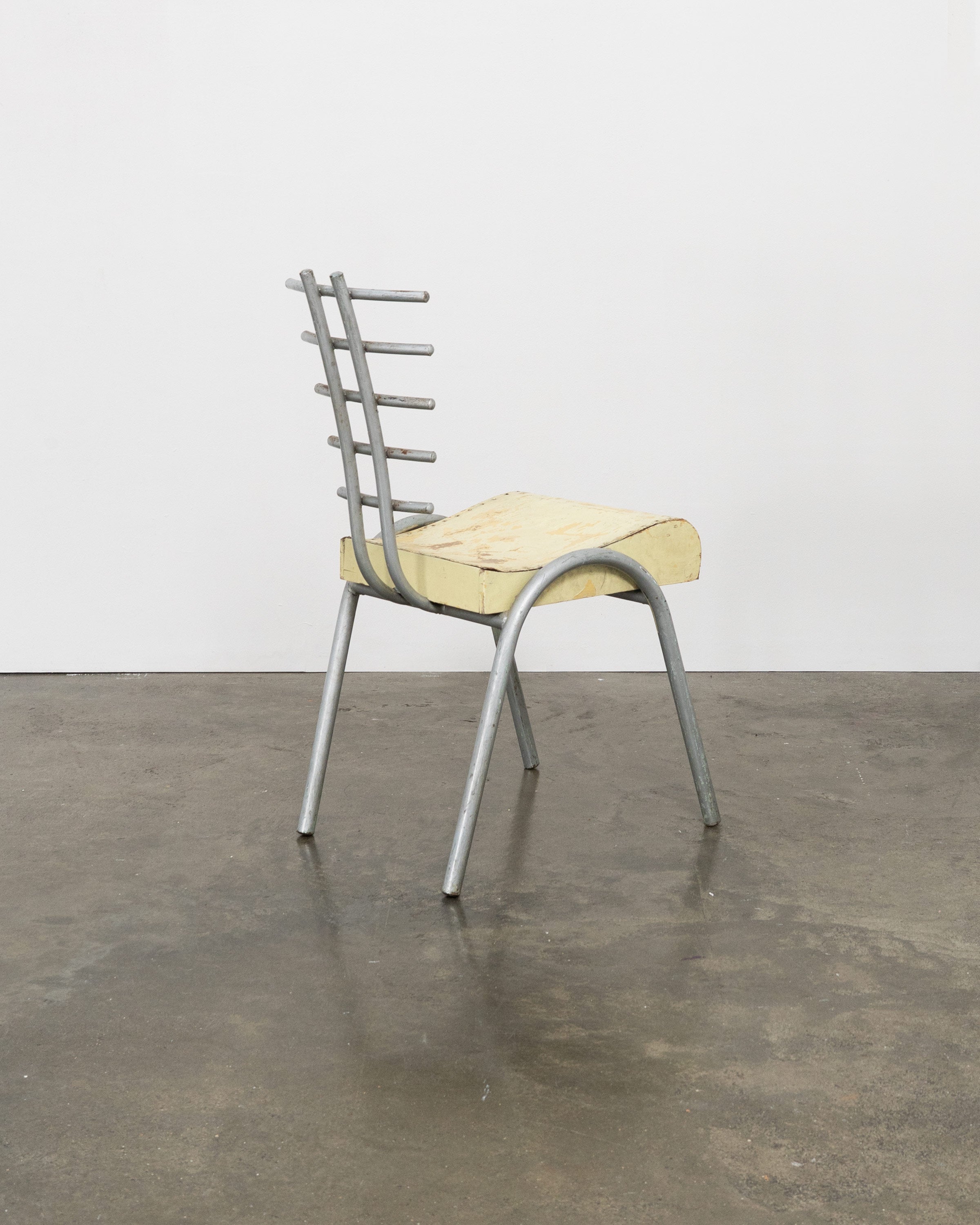 Postmodern prototype chair with ribbed metal backrest and foam cushion
