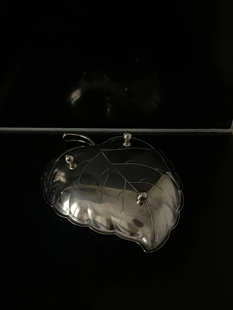 Silver leaf-shaped decorative dish with etched vein details