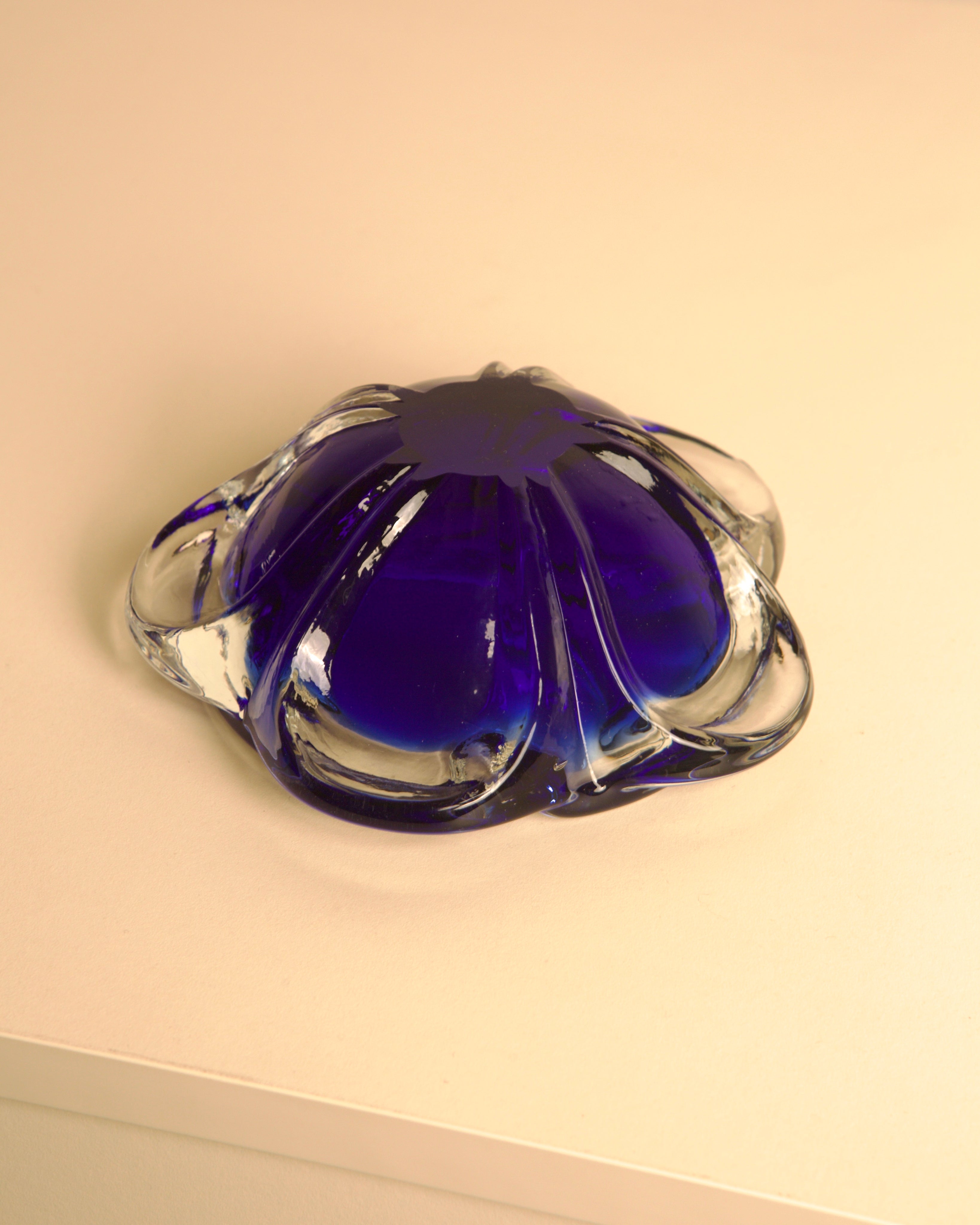 80's Blue Murano Glass "Flower" Ashtray — angled view on light surface