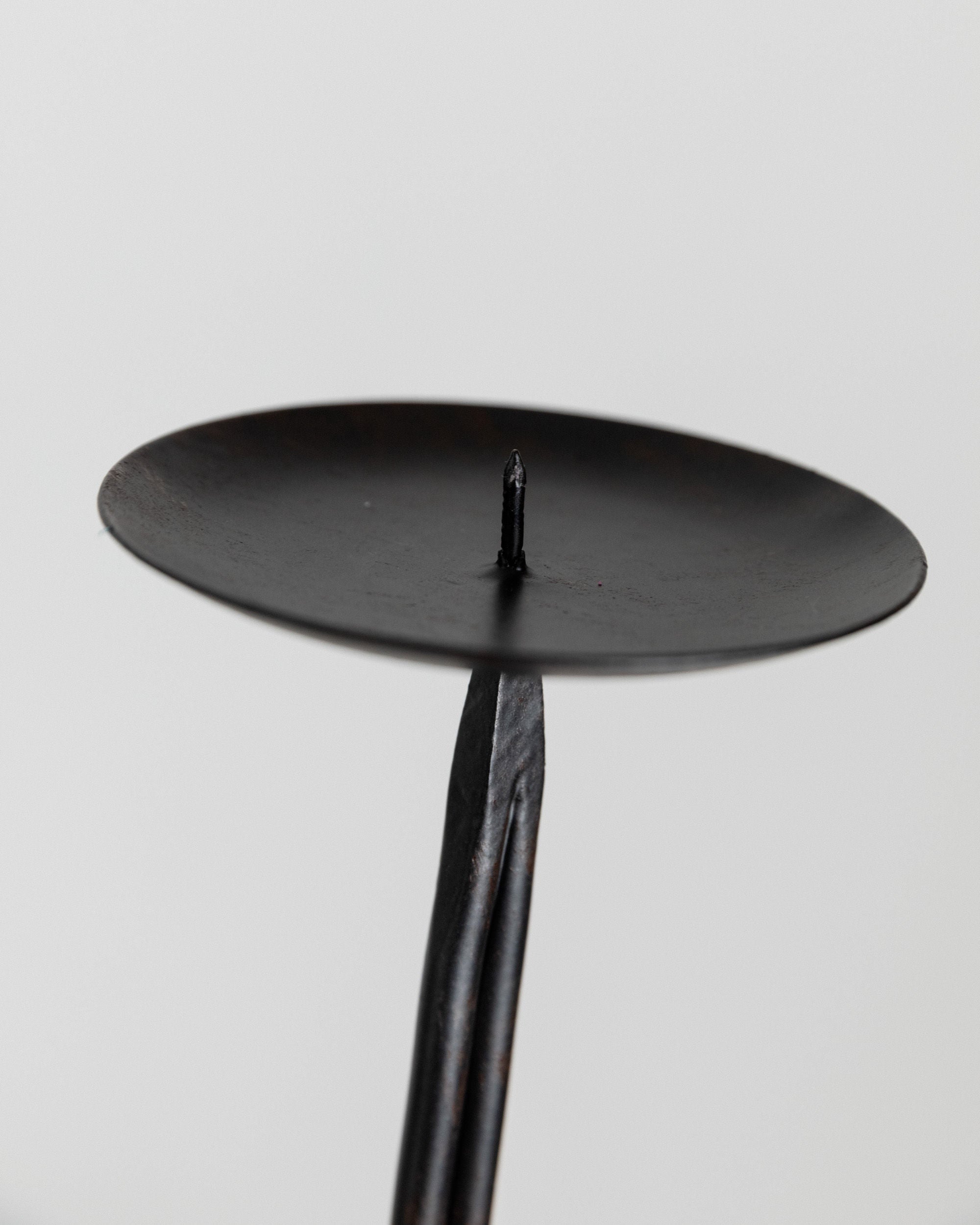 Candleholder Hand-forged Iron - Italy 1970s — close-up of black iron texture