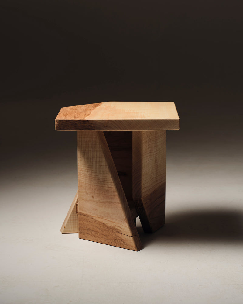 Maple wood stool with crossed base support, side view detail