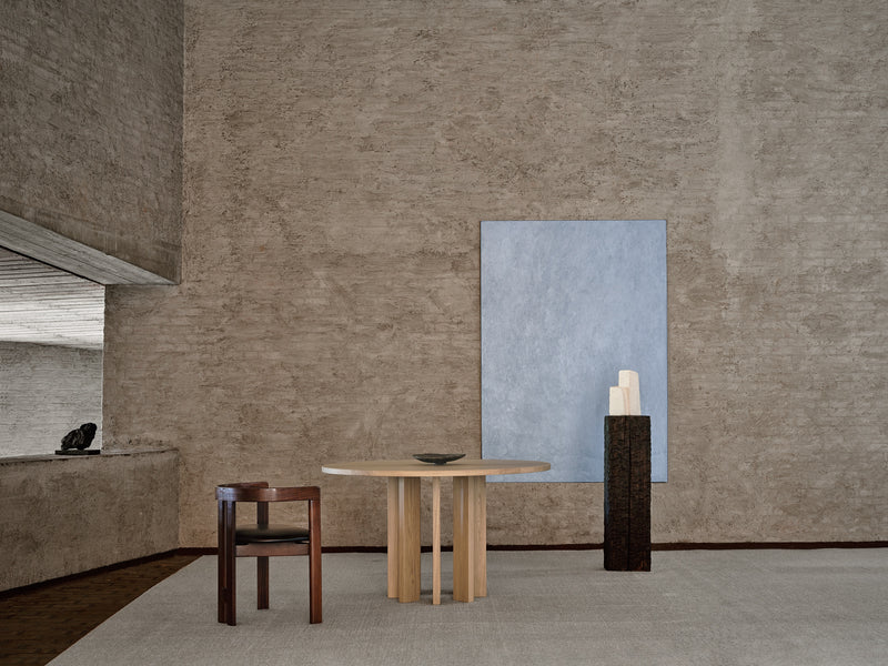 Thola Round Table — close-up of wooden surface in minimalist setting