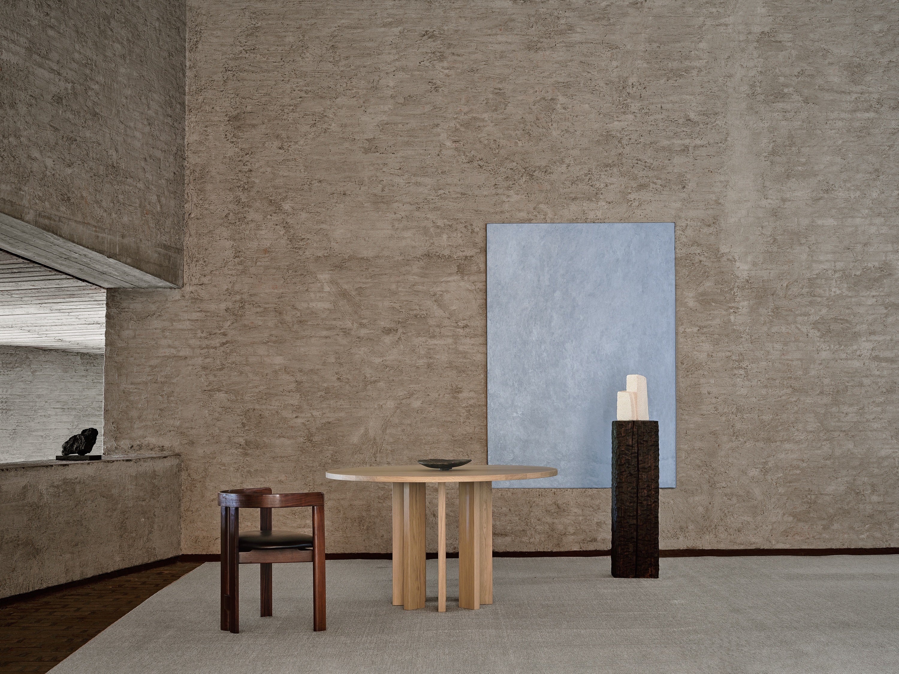Thola Round Table — close-up of wooden surface in minimalist setting