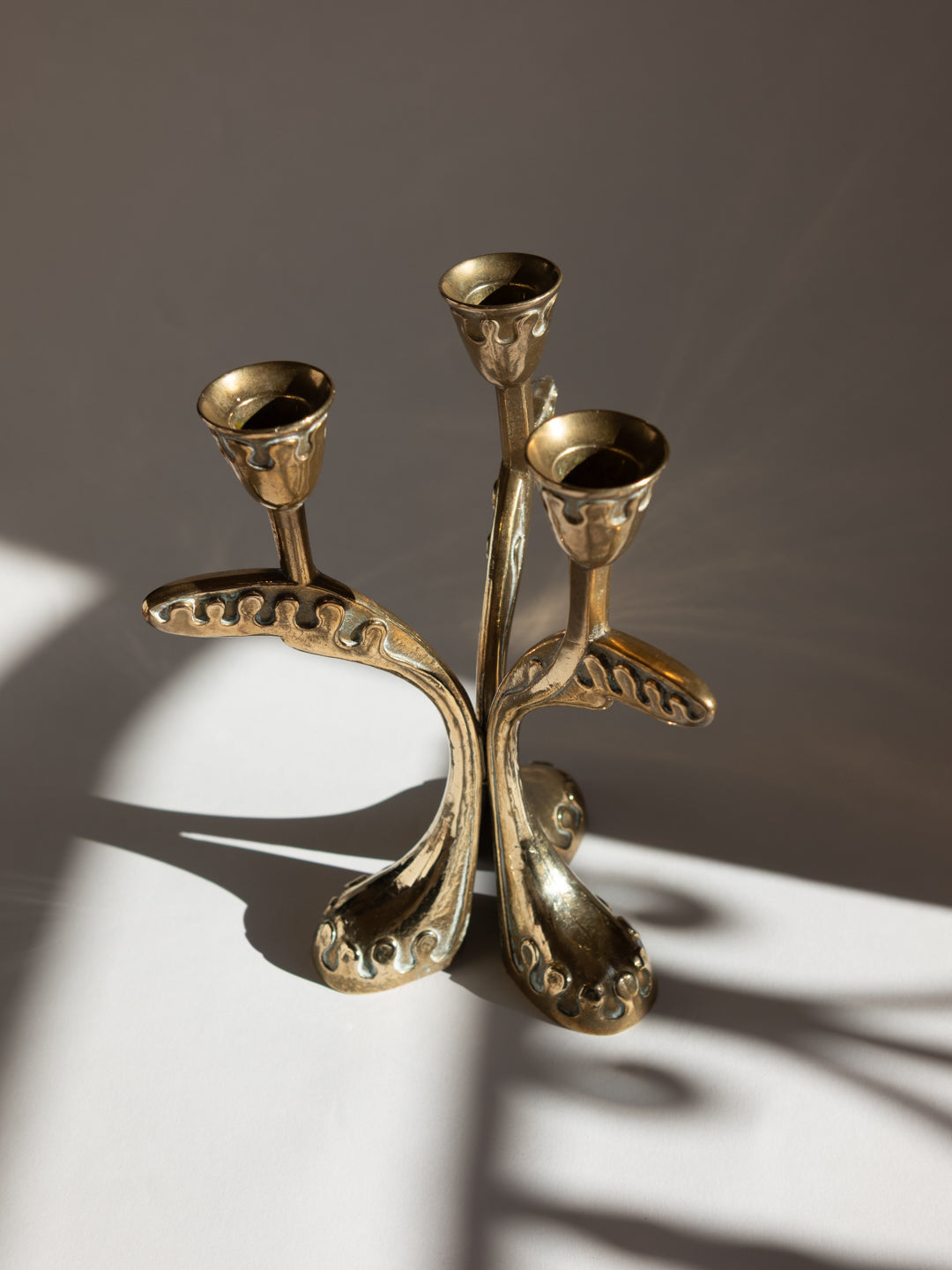 Brass Secessionist Three-Arm Candelabra - Austria, c. 1930s — angled view highlighting organic shapes and brass finish