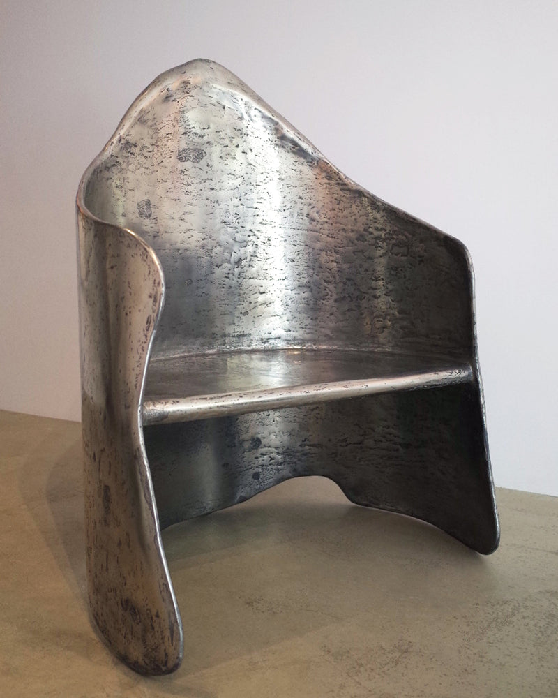 AMAIA sculptural aluminum-brass resin armchair with curved form