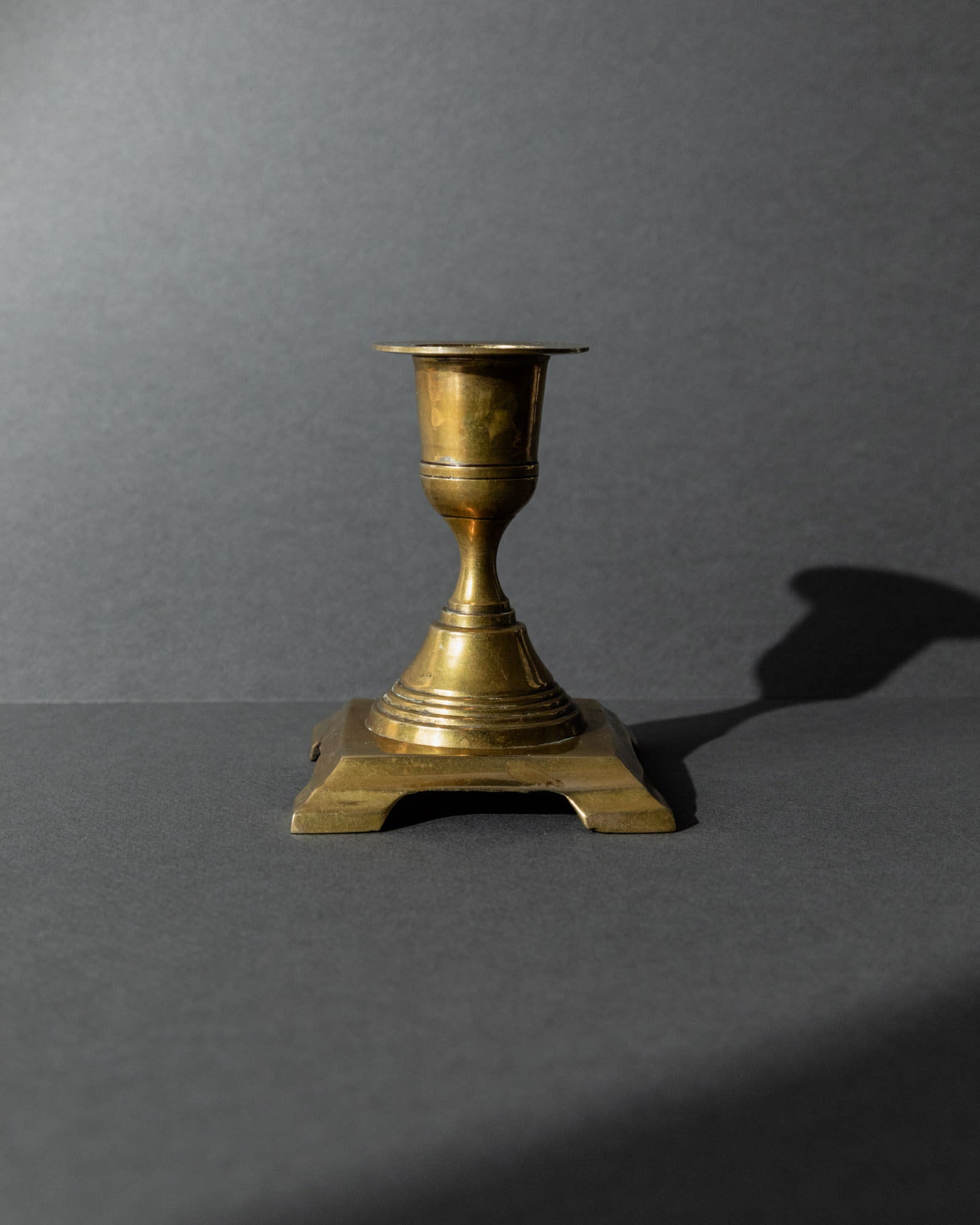 Vintage 1940s Brass Candleholders Set of 3, Mixed Shapes, Classic Antique Design — angled view highlighting brass texture and