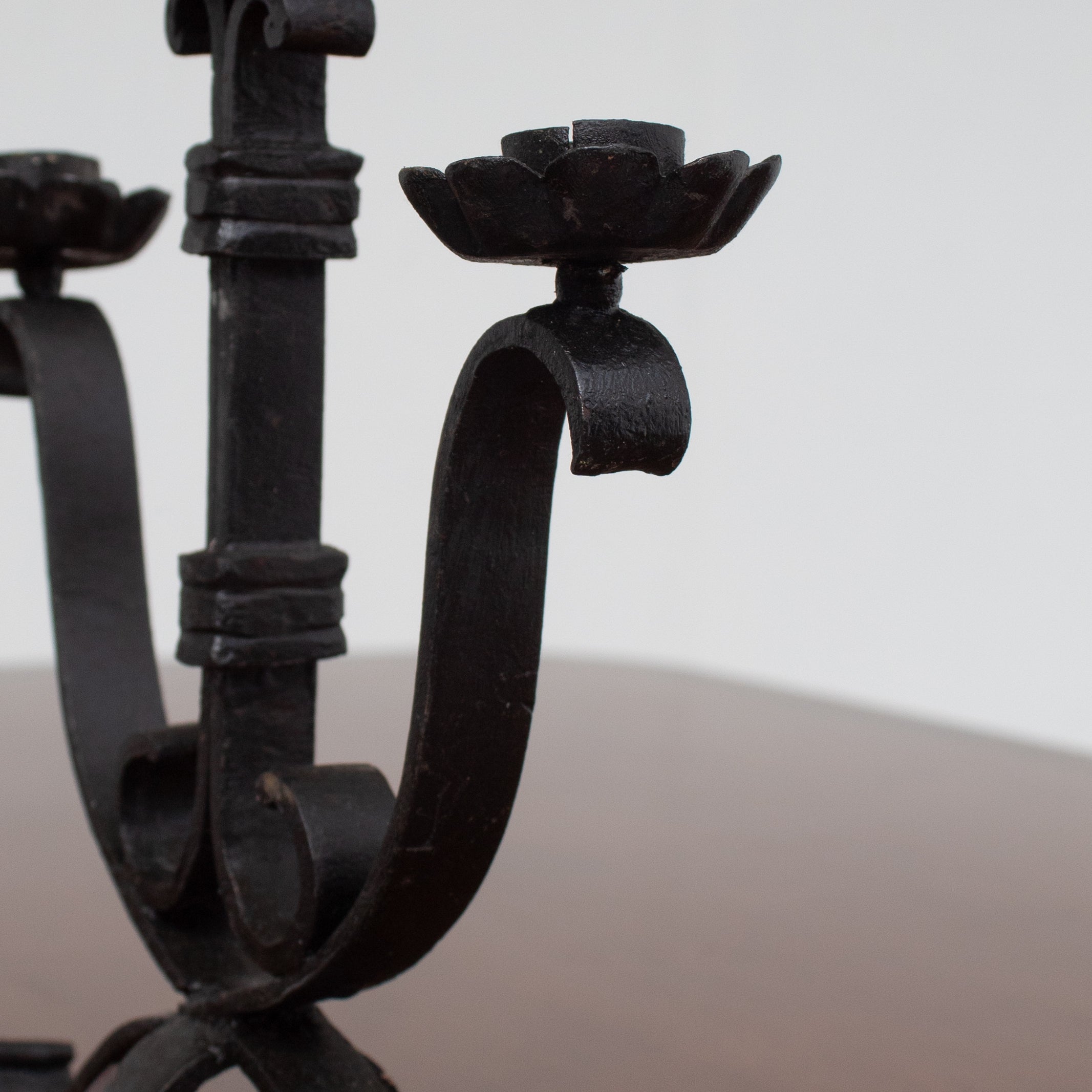 Pair of Brutalist Iron Candleholders with Sculptural Scroll Arms — lifestyle setting