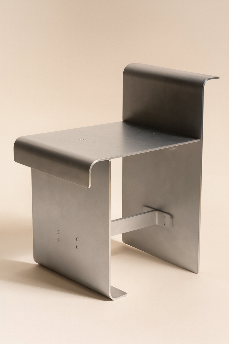 Modern aluminum chair with curved backrest and minimalist design by Caleb Engstrom