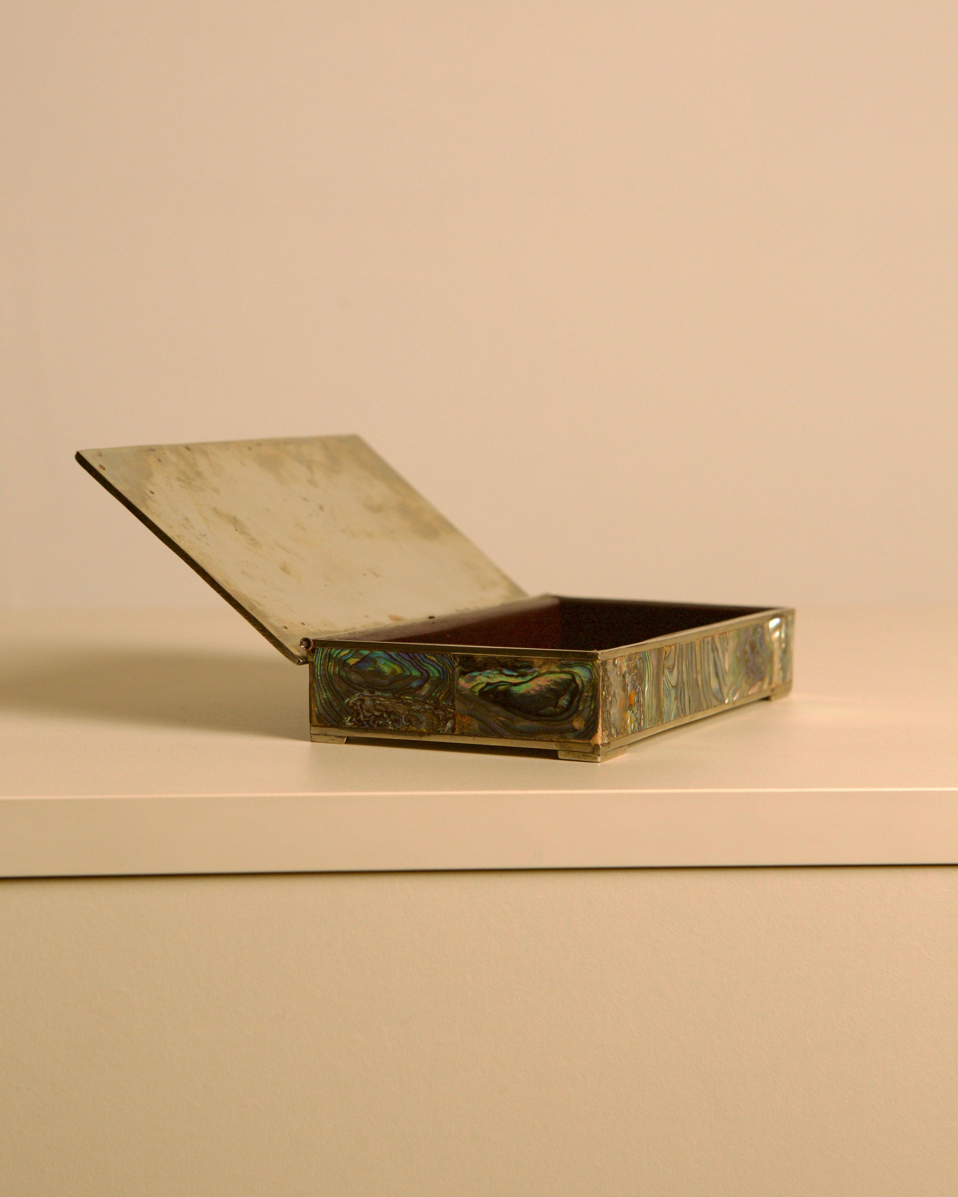 Italian Rectangular Silver and Mother-of-pearl Inlaid Box 40s — angled view with open lid on white surface