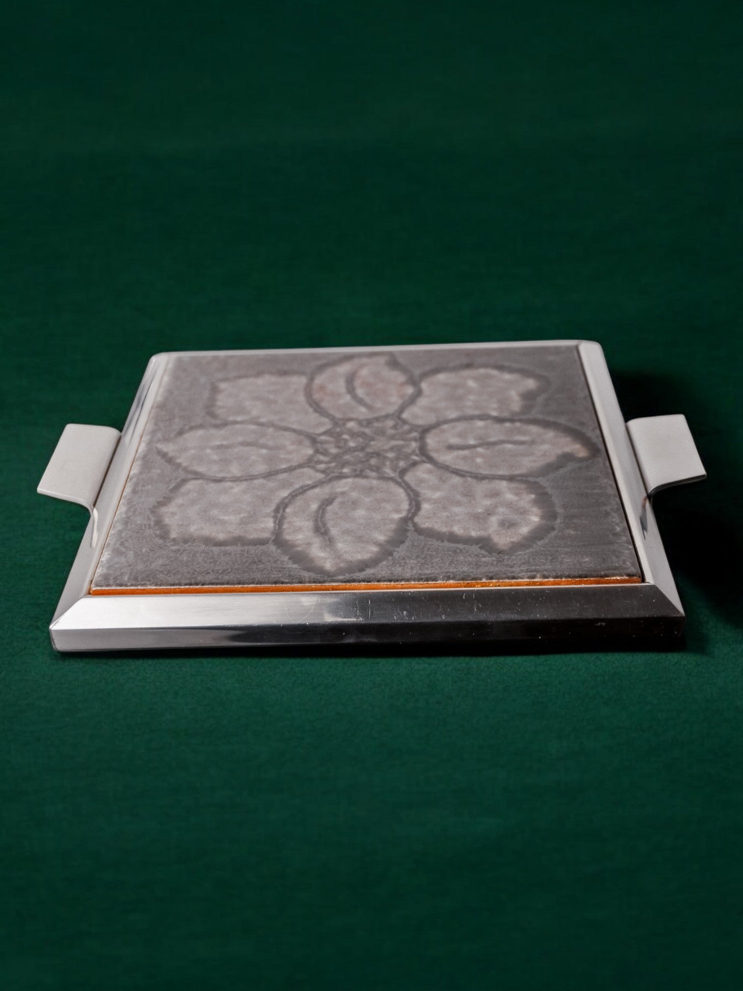 Space Age Floral Grey Ceramic Trivet, Spain, 1970's — side angle showing ceramic surface and metal handles