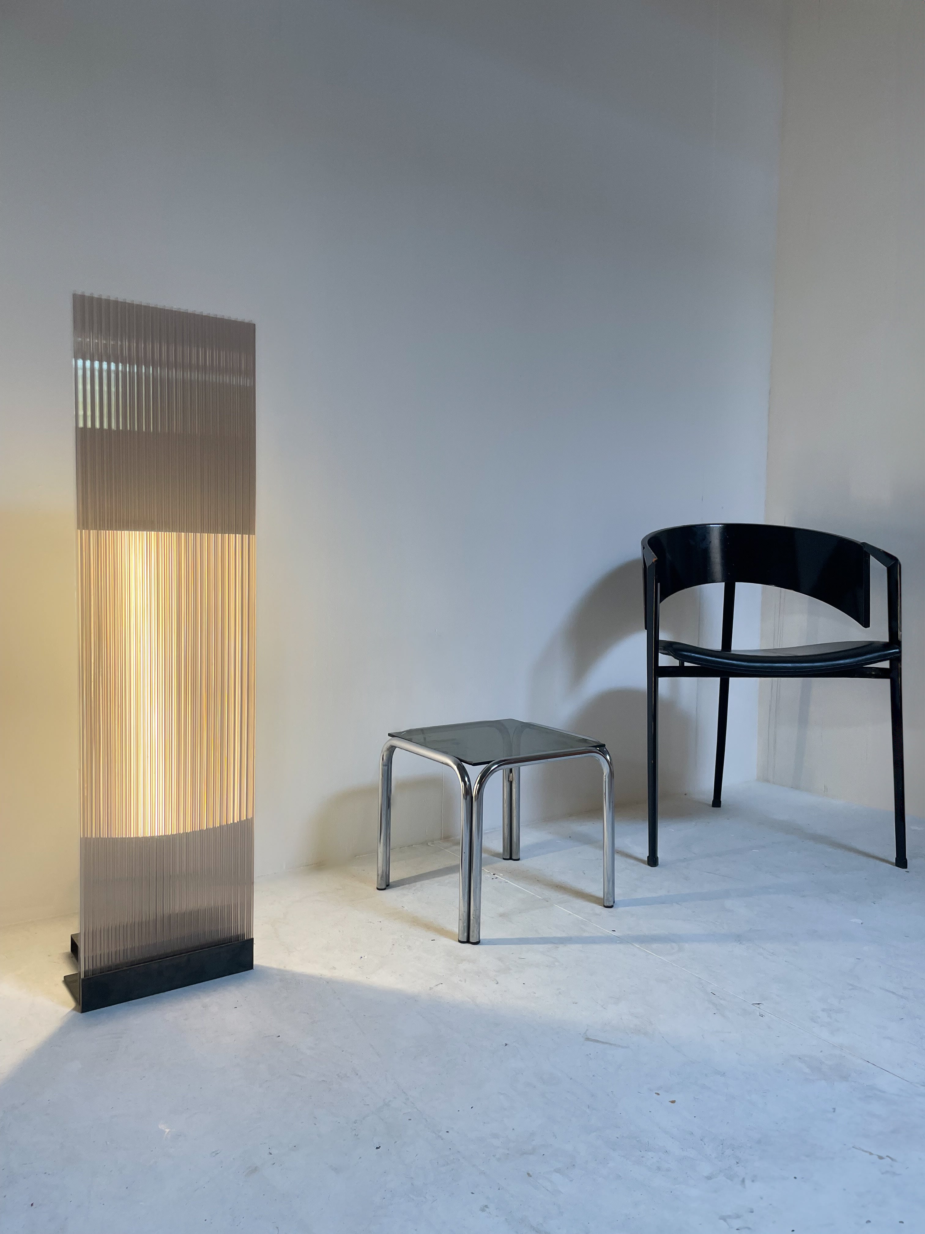 POLY-C-1 extra tall - smoke — angled view beside modern chair