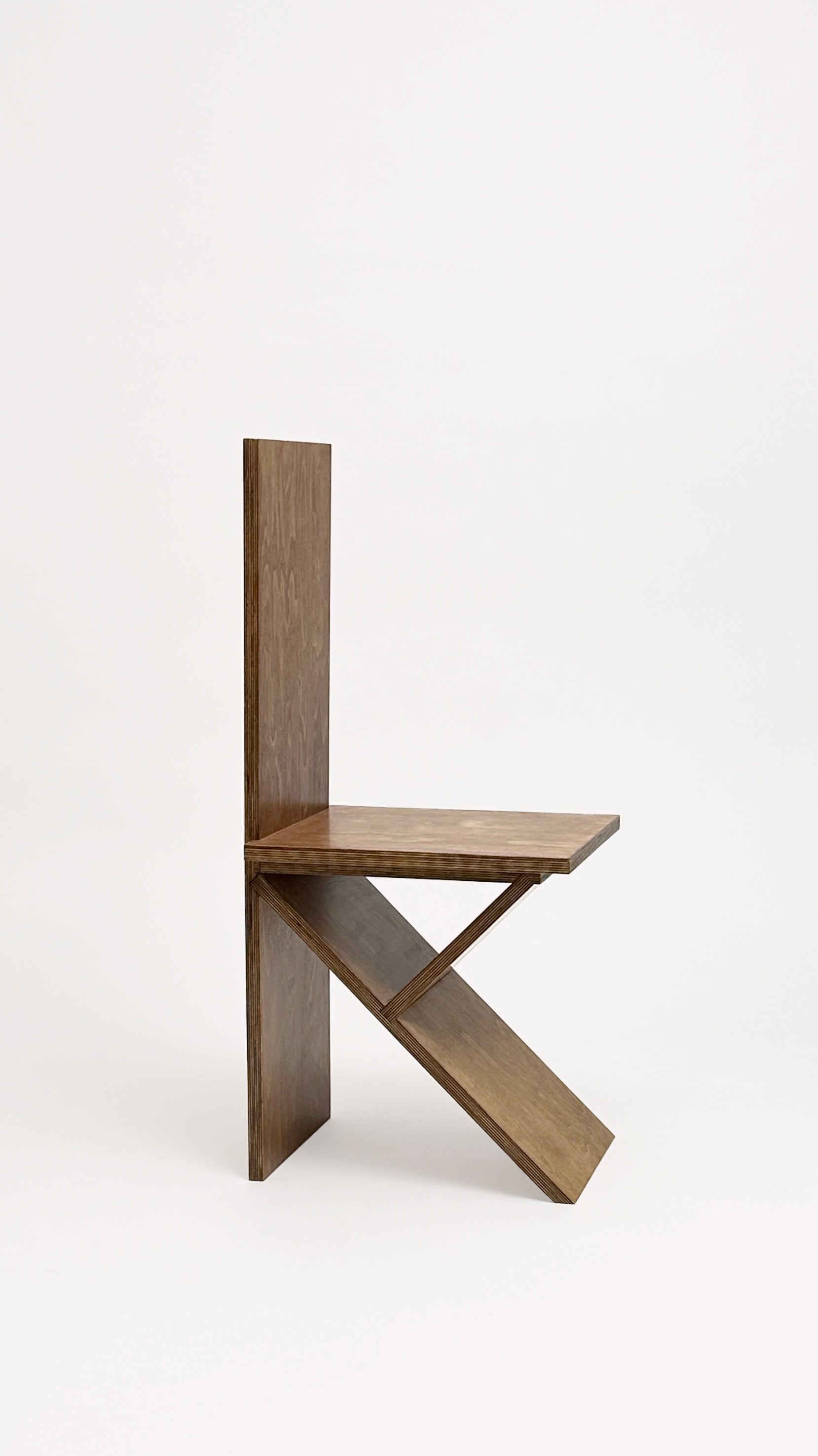 The Flat Pack Chair by Goons from brand GOONS features a straight vertical back, flat seat, and angled support for a geometric, sculptural look against a plain white background.