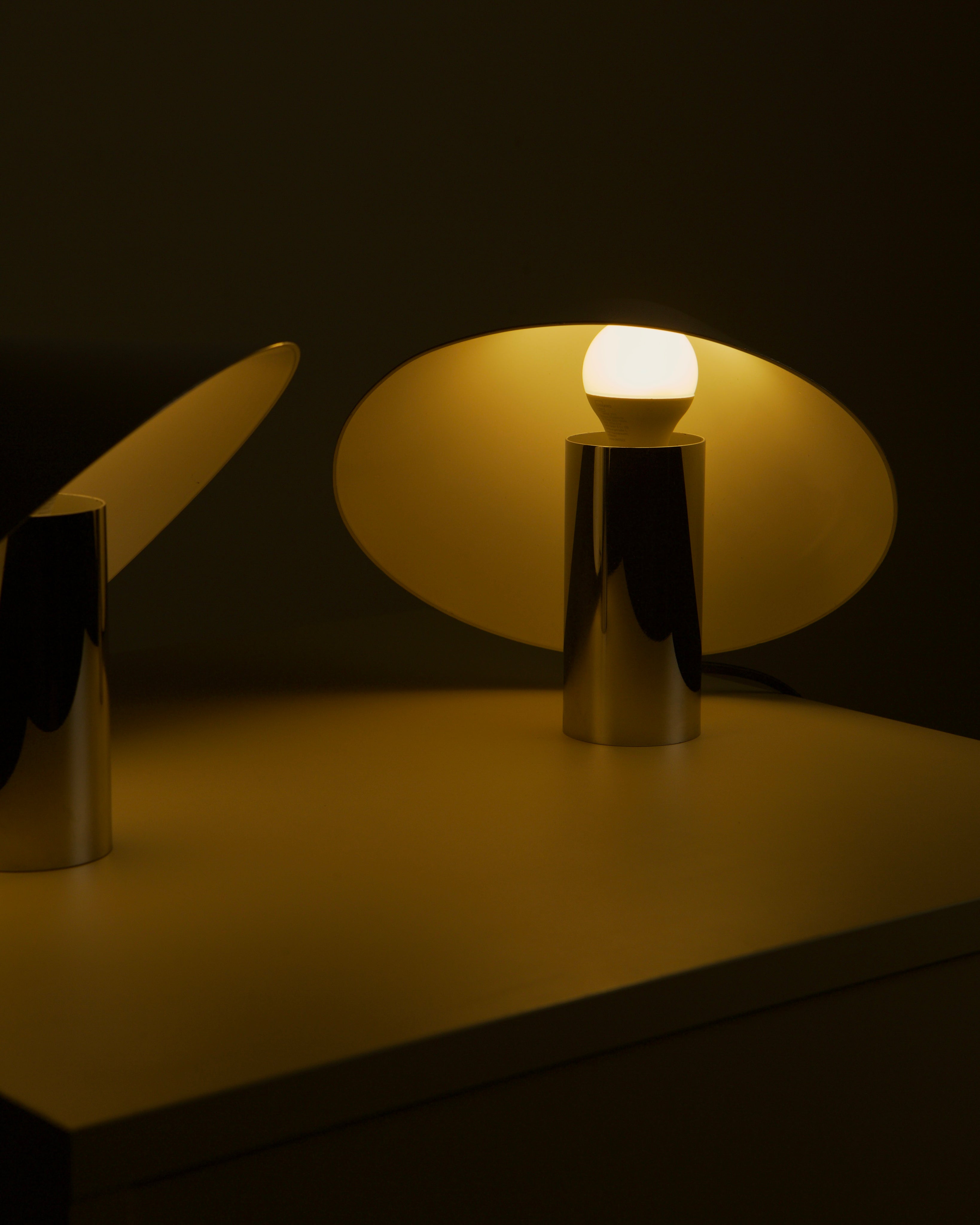 Illuminated Pulcino table lamps warm golden glow display