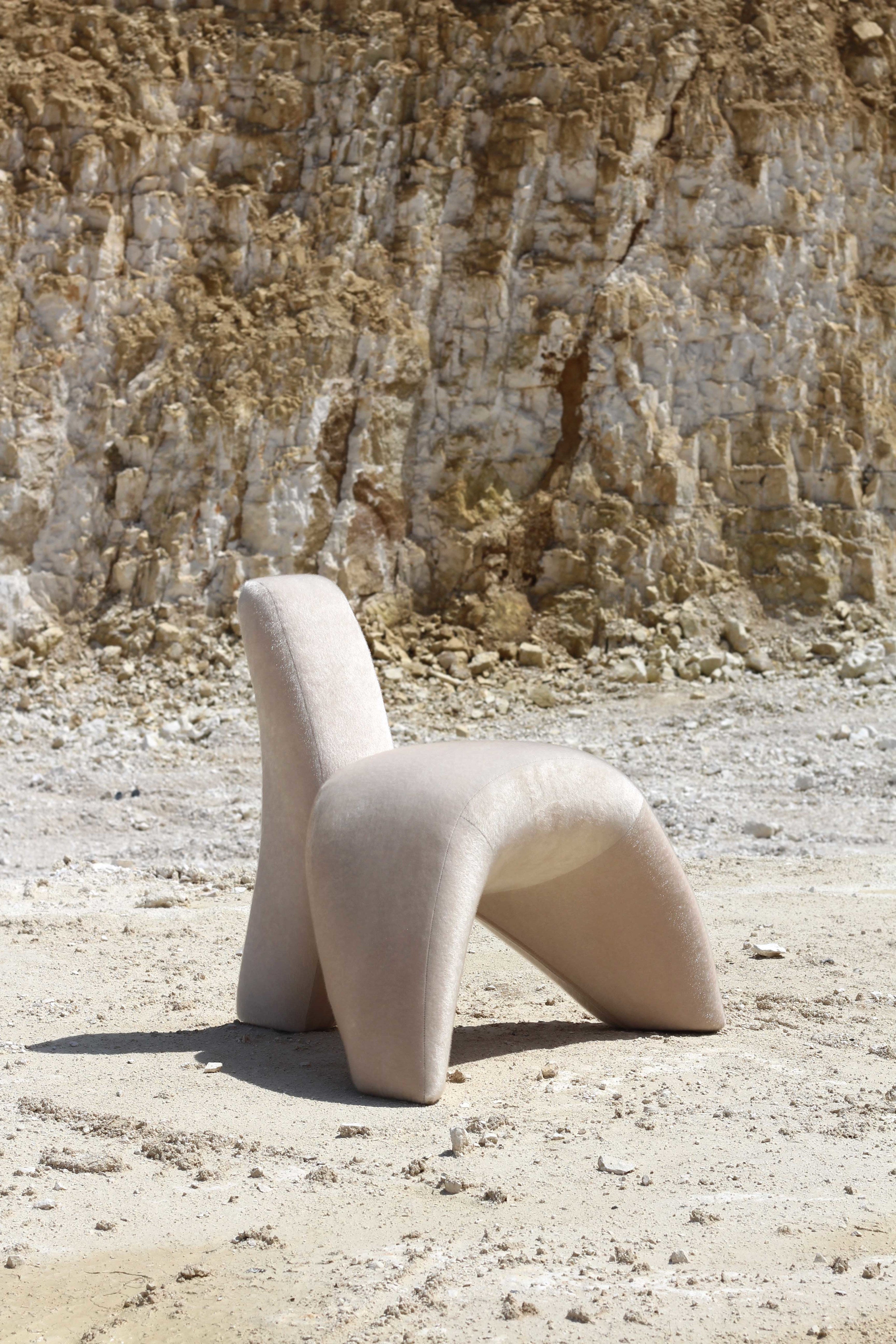 Sokil armchair — back view on sandy outdoor setting