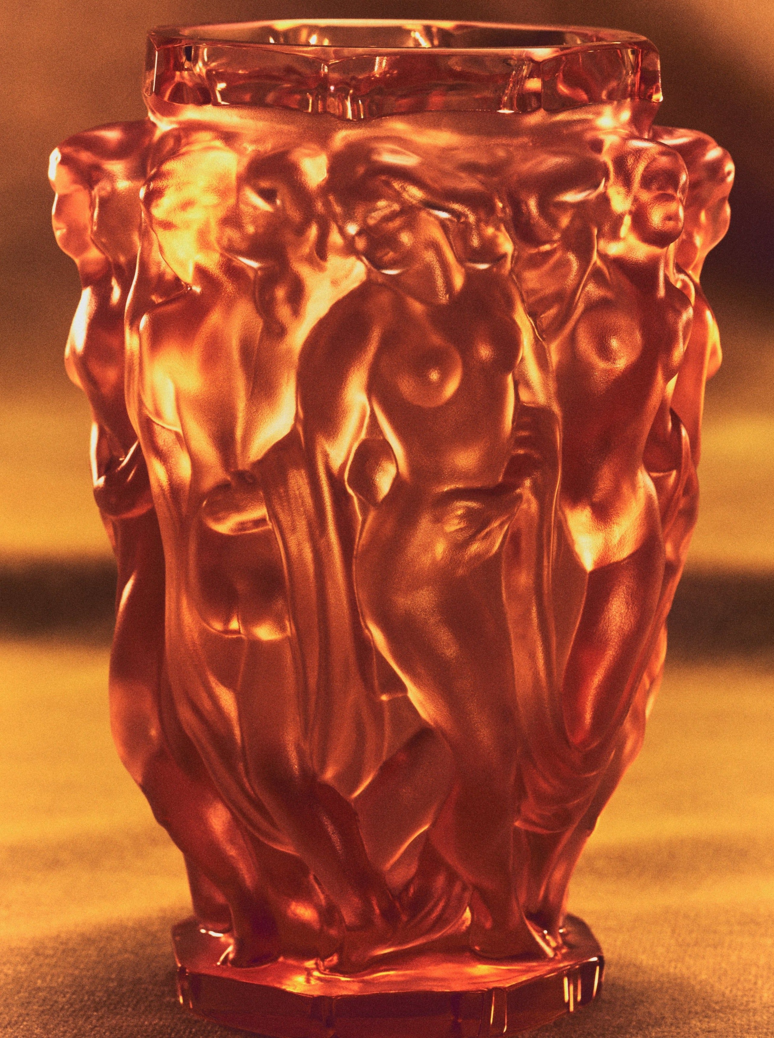 Michael Vase — close-up of amber glass with detailed figures