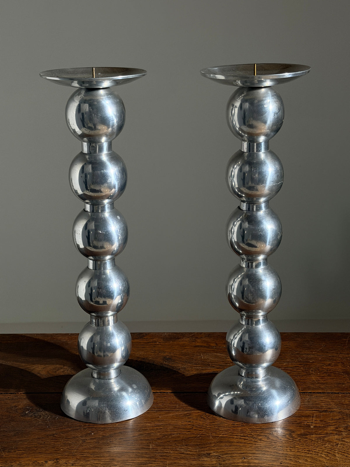 Pair of large aluminum candlesticks, France, circa 1970. — side angle