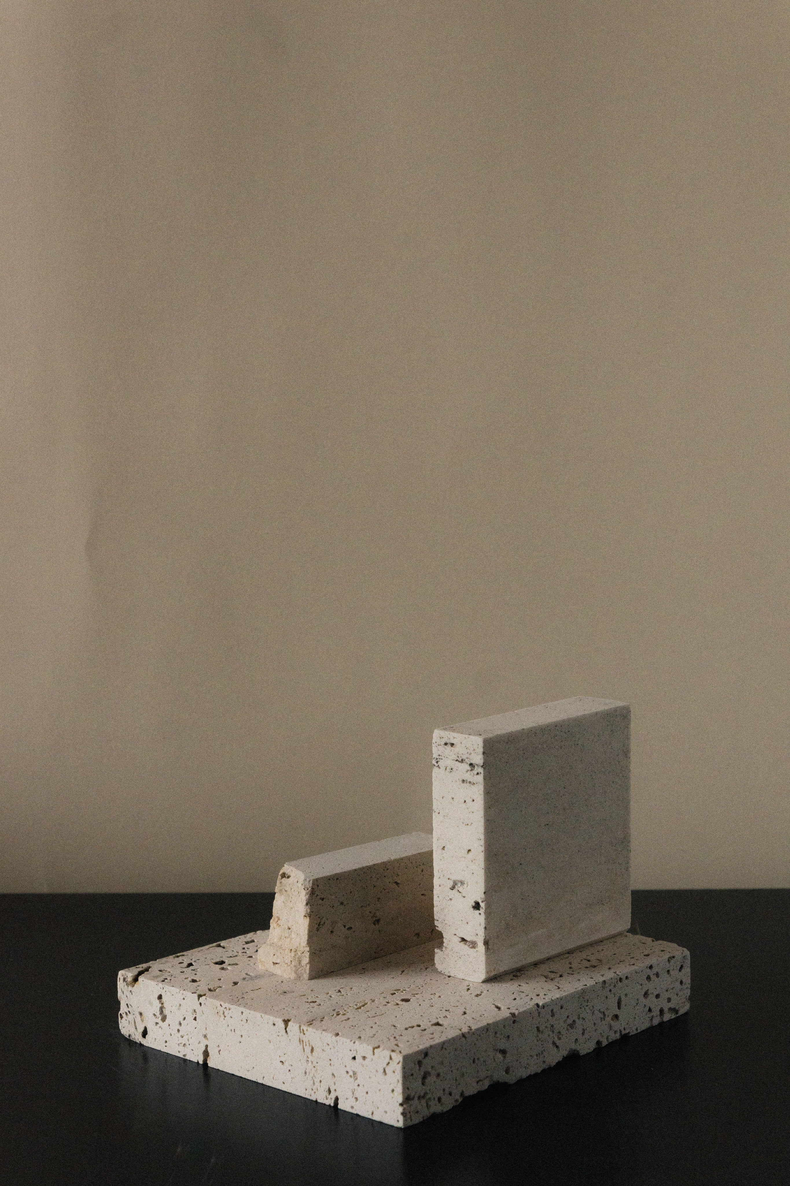 Monument II - Handmade Travertine Marble Bookstand — close-up of textured stone surface