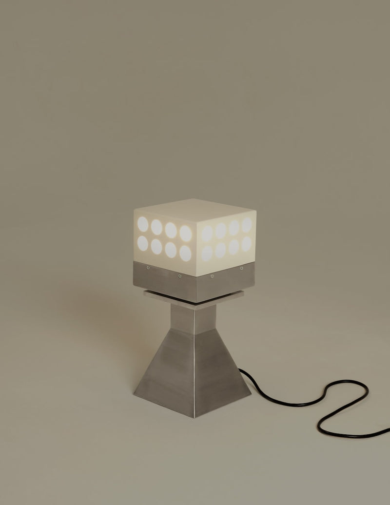Illuminated Vardo table lamp with geometric cube shade on pyramid base