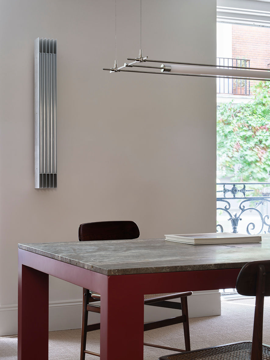 Firme Dining Table — close-up of concrete top with red legs