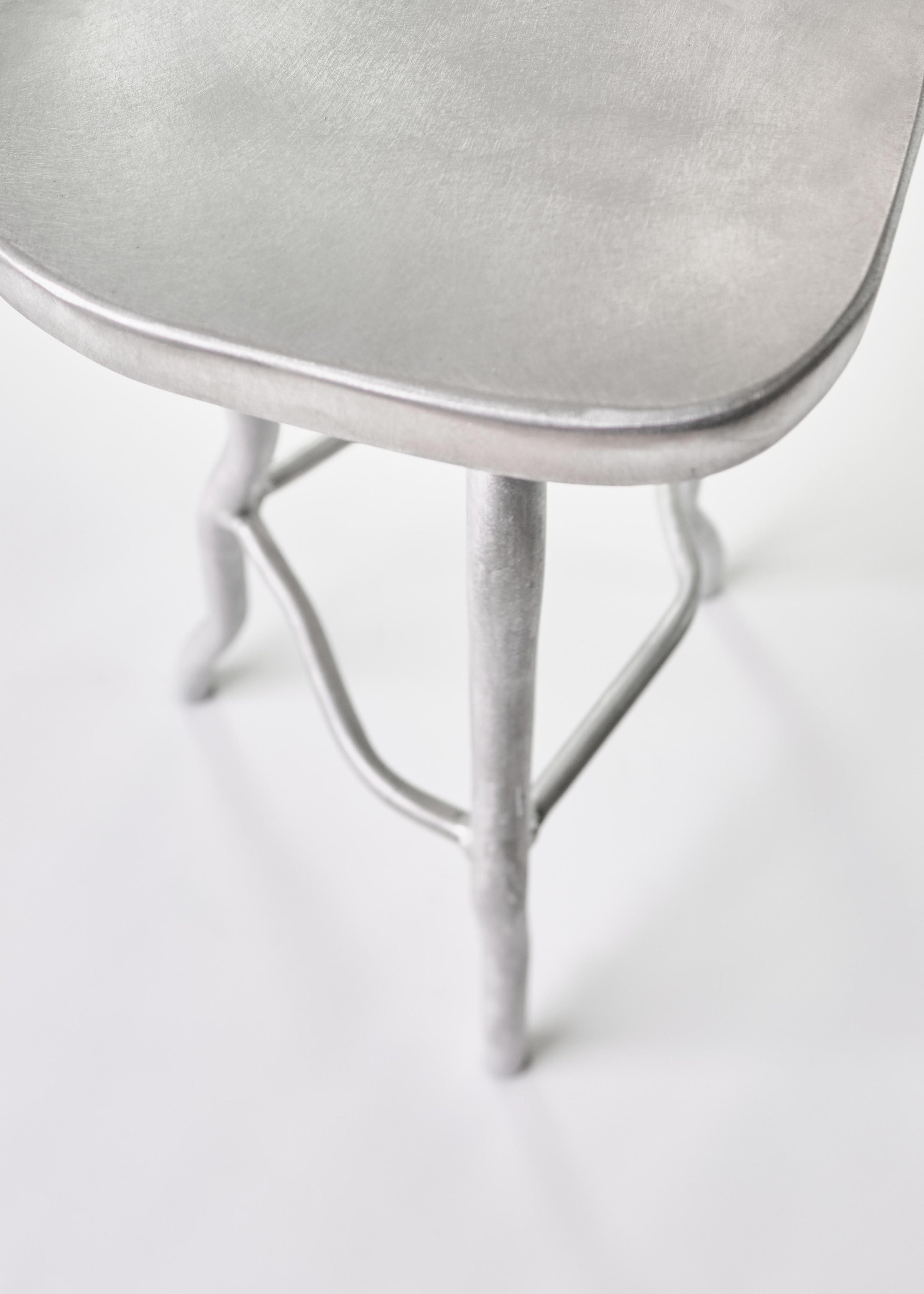 Bar Stool — angled view of brushed metal seat and legs