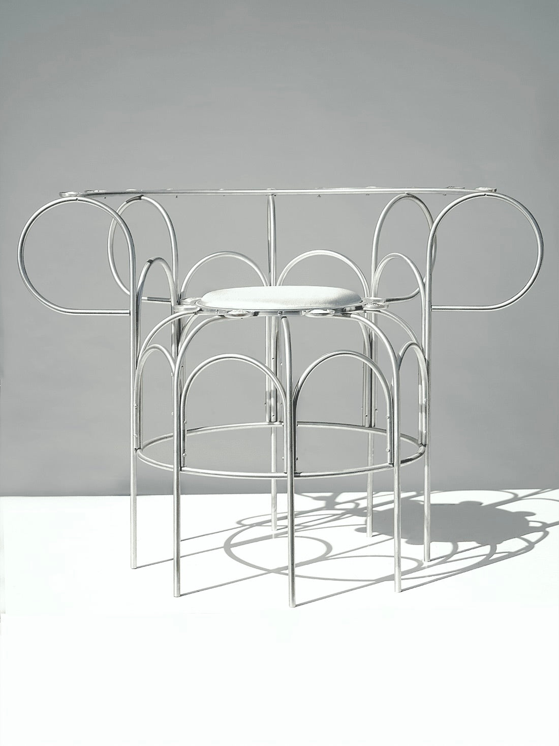 The Armchair With Shells — angled view of metal frame design