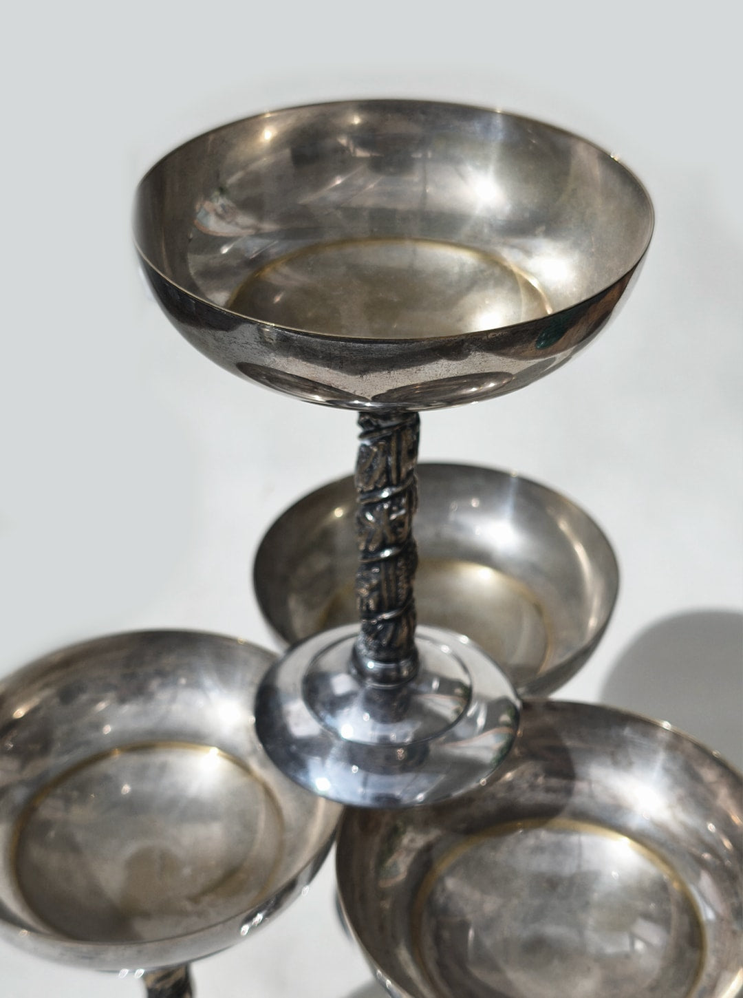 Ornate silver serving cups with twisted stem pedestal base detail