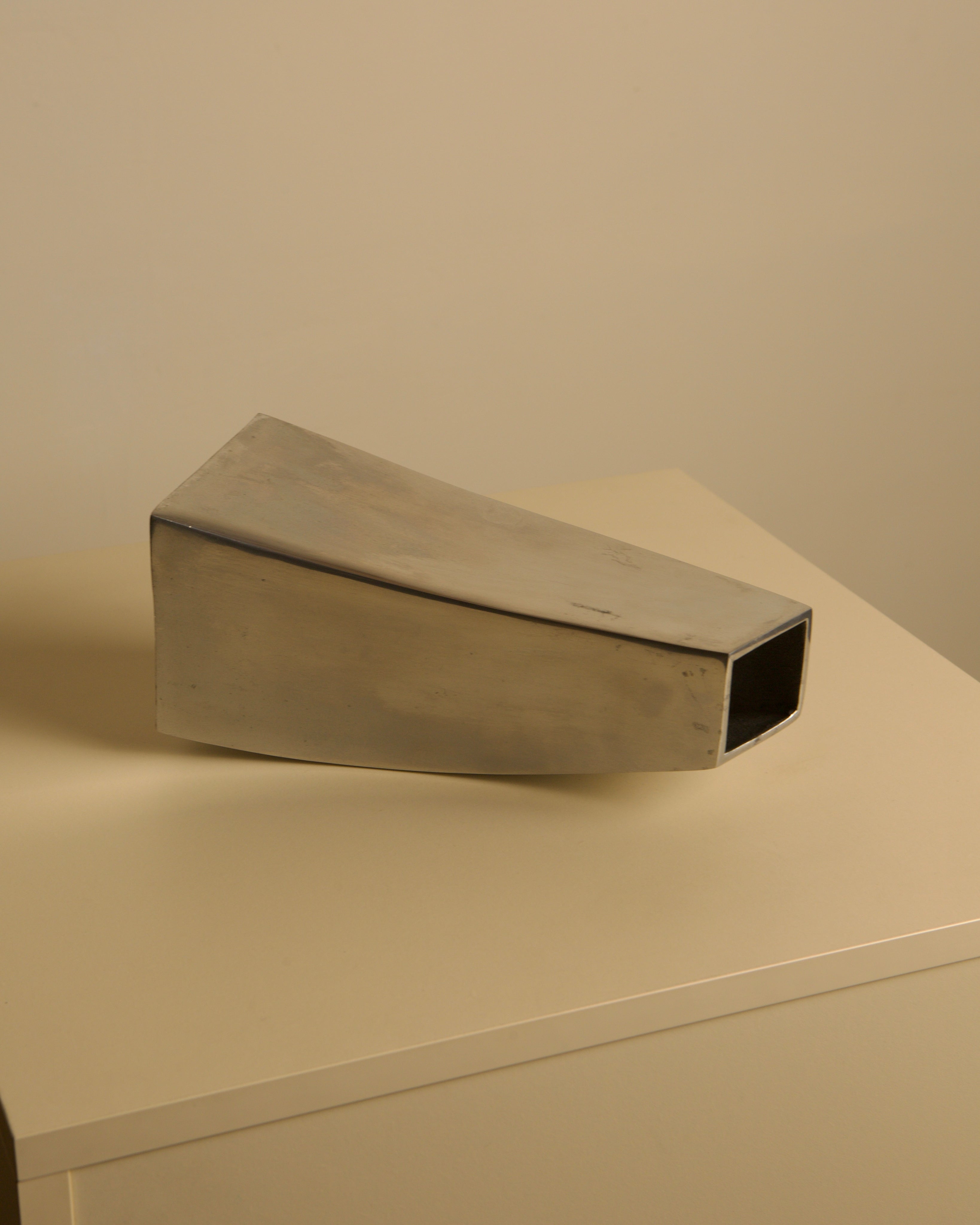 Corne vase in cast aluminum, 80s — angled view on neutral background