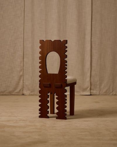 Jura dining chair profile view showing decorative carved backrest