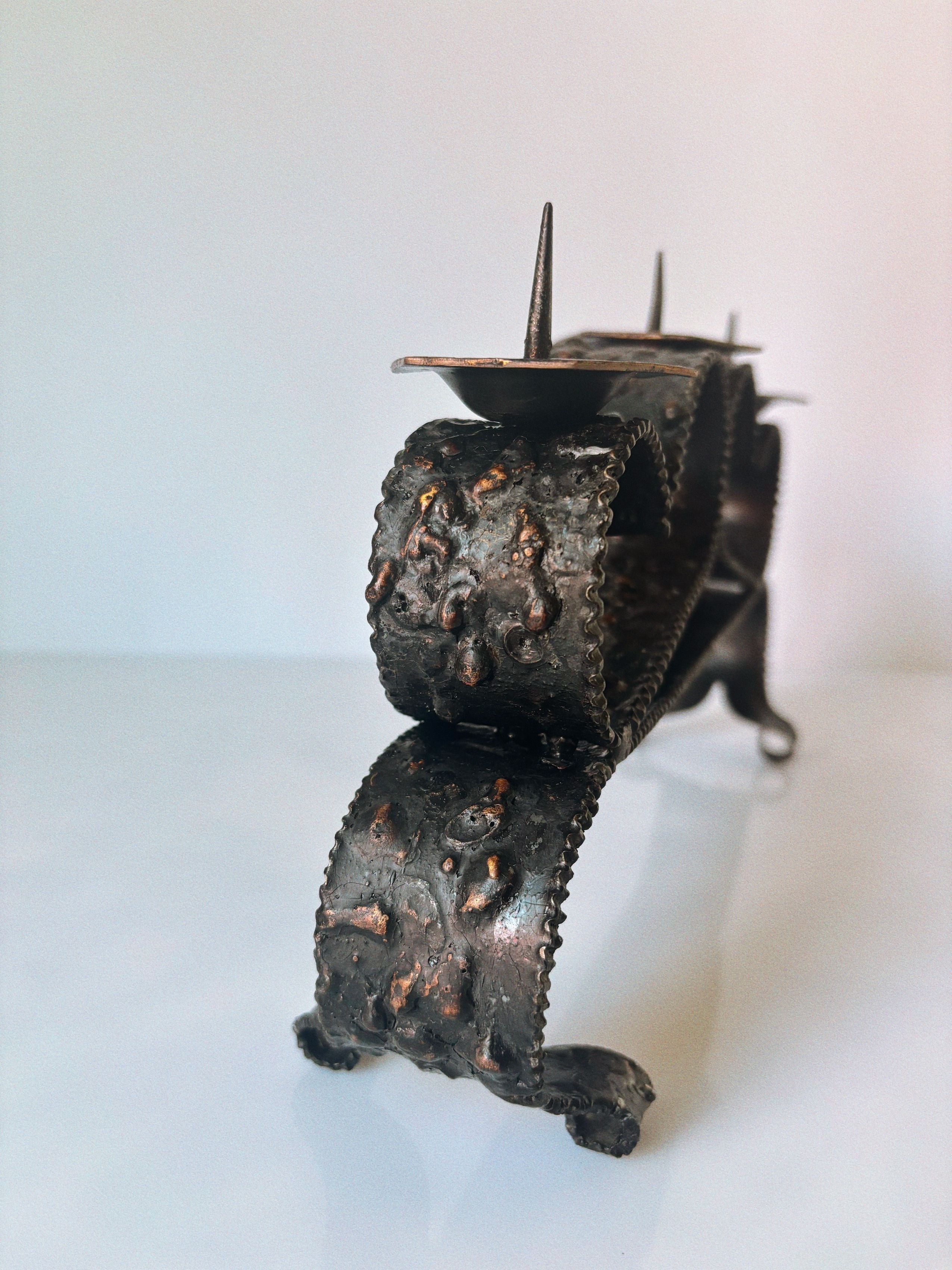 Dark textured metal candleholder with decorative studs from Poland