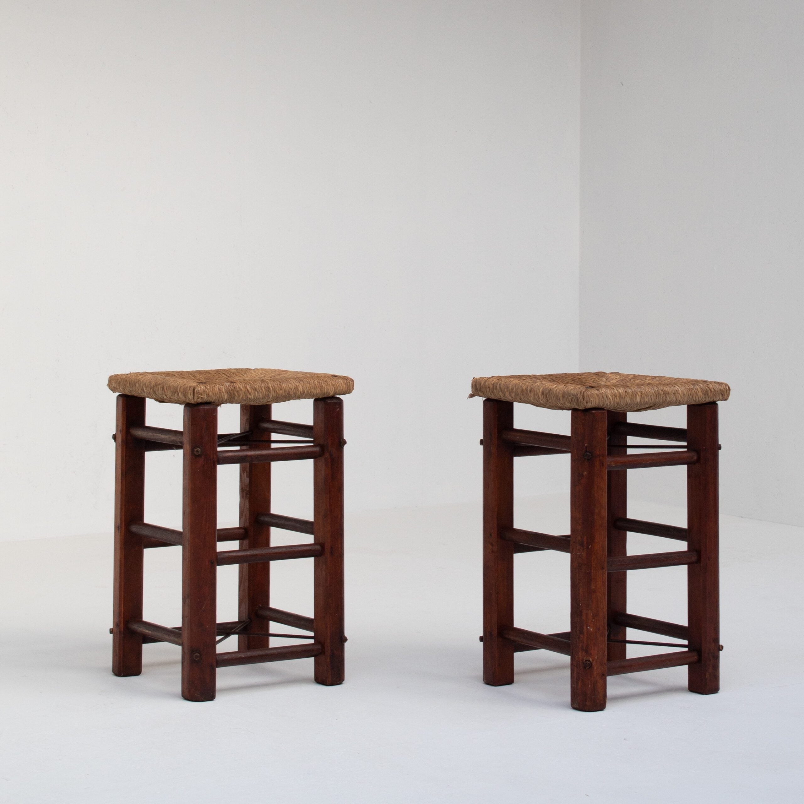 Pair of Rustic Wooden Stools with Woven Rush Seats — side angle showing sturdy wooden legs