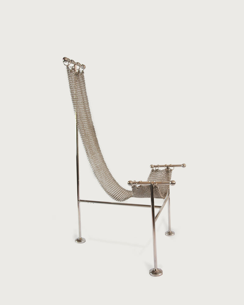 Chainmail steel chair side profile showing sculptural frame legs