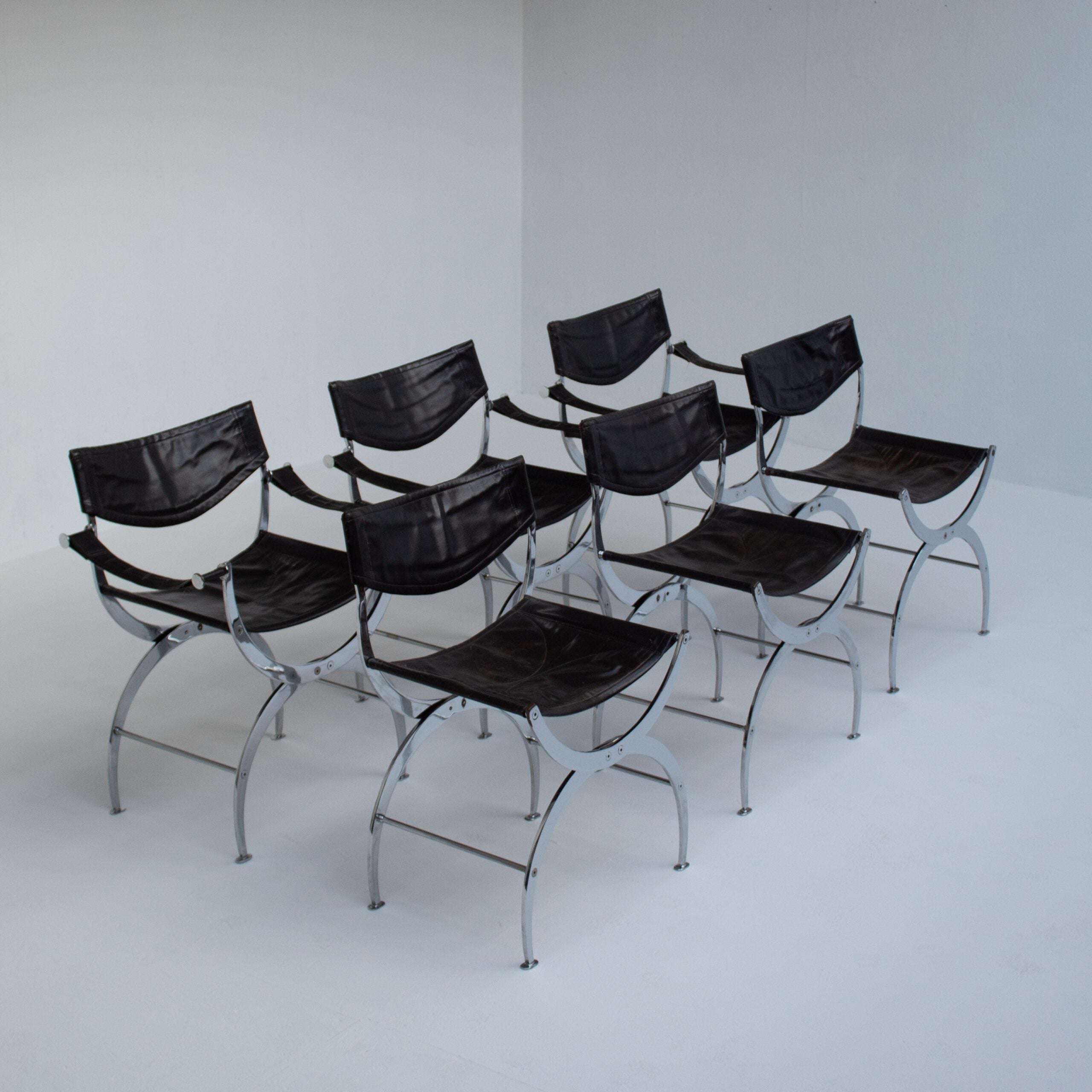 Set of 6 Italian Chrome Dining Chairs with Leather Seating — side view showing chrome frame and black leather seats