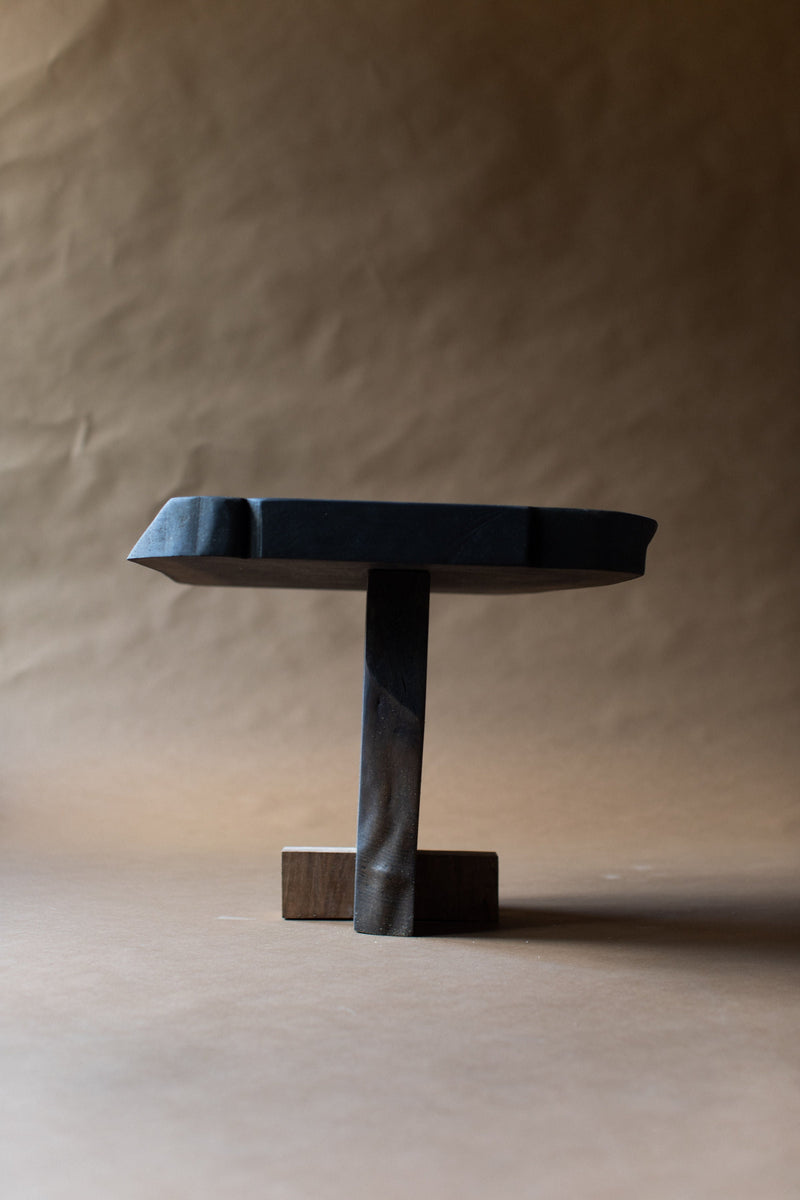 Black wooden Qawha side table with cylindrical pedestal base