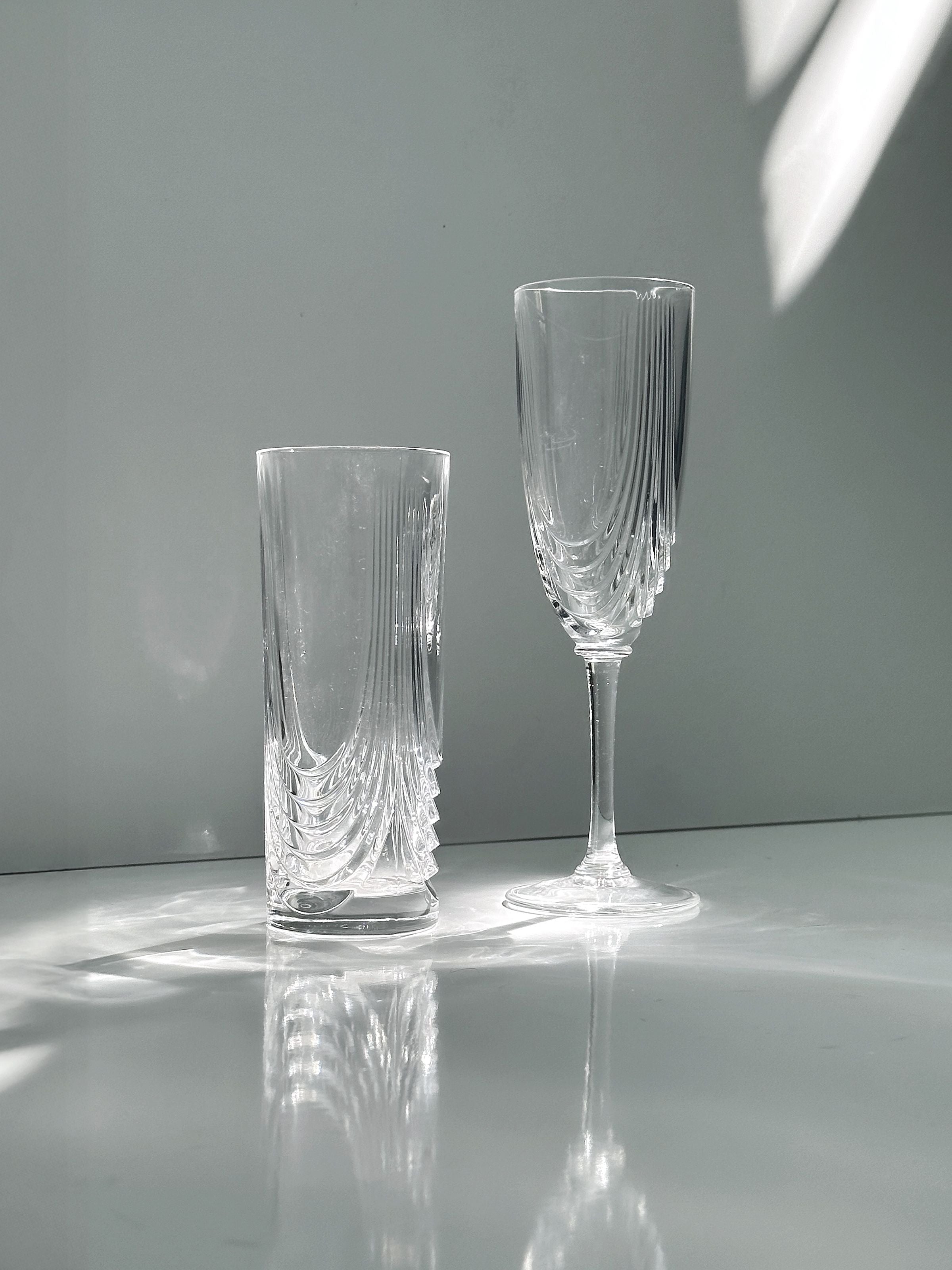 2 Italian Art Deco Crystal Glass Sets of 8 and 6 — close-up of textured crystal glasses on white surface