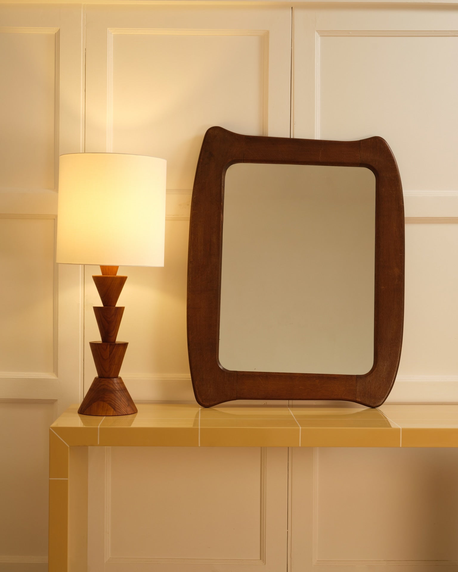 Wooden organic mirror — top view on yellow tiled console