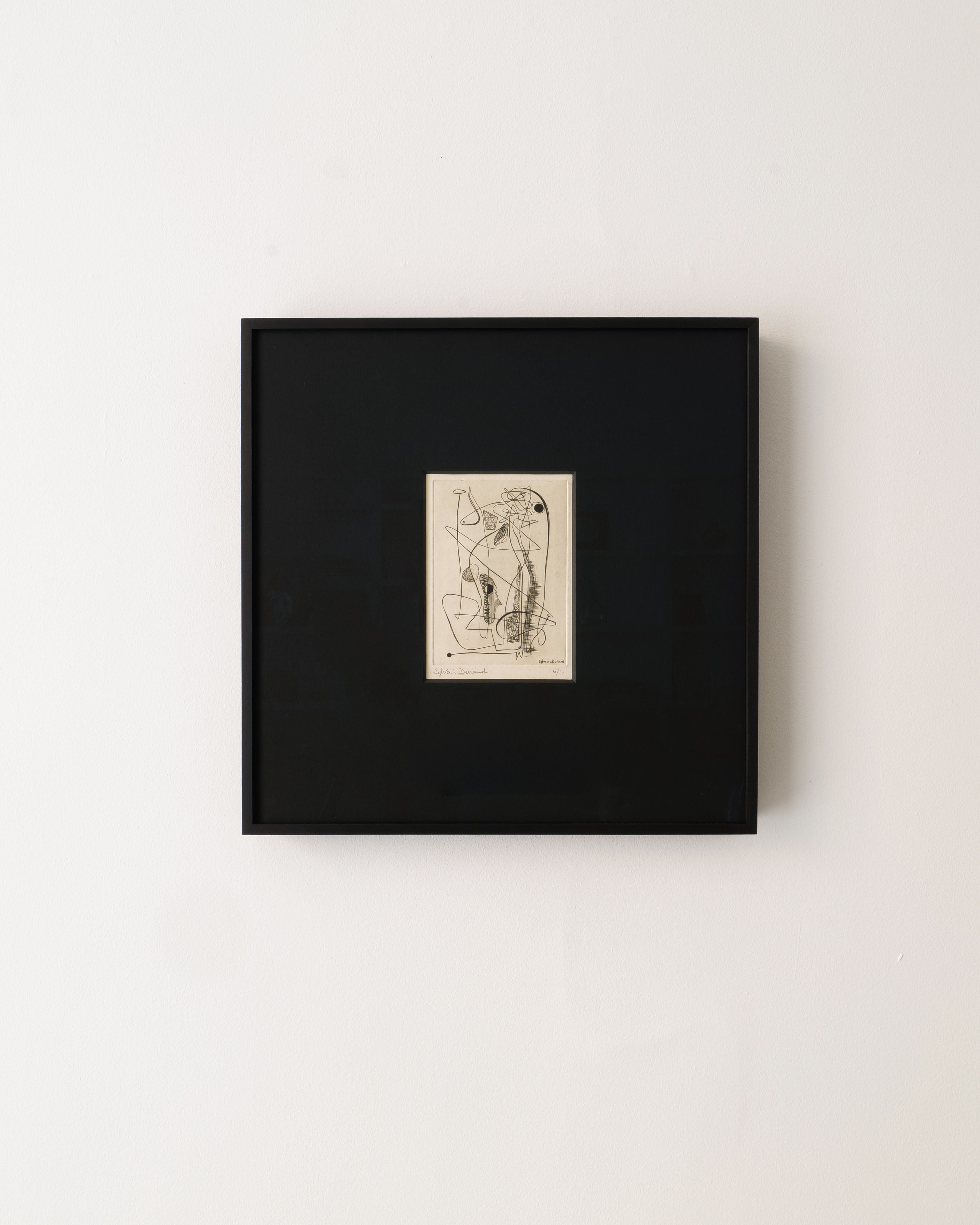 Surrealist Engraving Signed Sylvain Durand by Collection apart, in a black frame, hangs on a white wall. The artwork showcases intersecting curved and straight lines in an intricate minimalist composition.