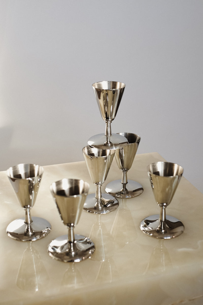 Set of 6 Coupes — close-up of polished metal on marble surface