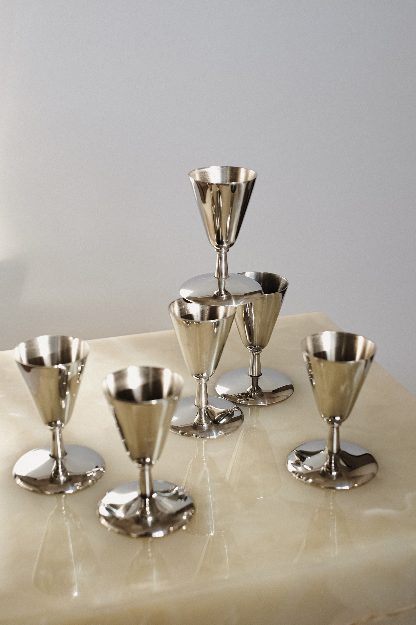 Set of 6 Coupes — close-up of polished metal on marble surface