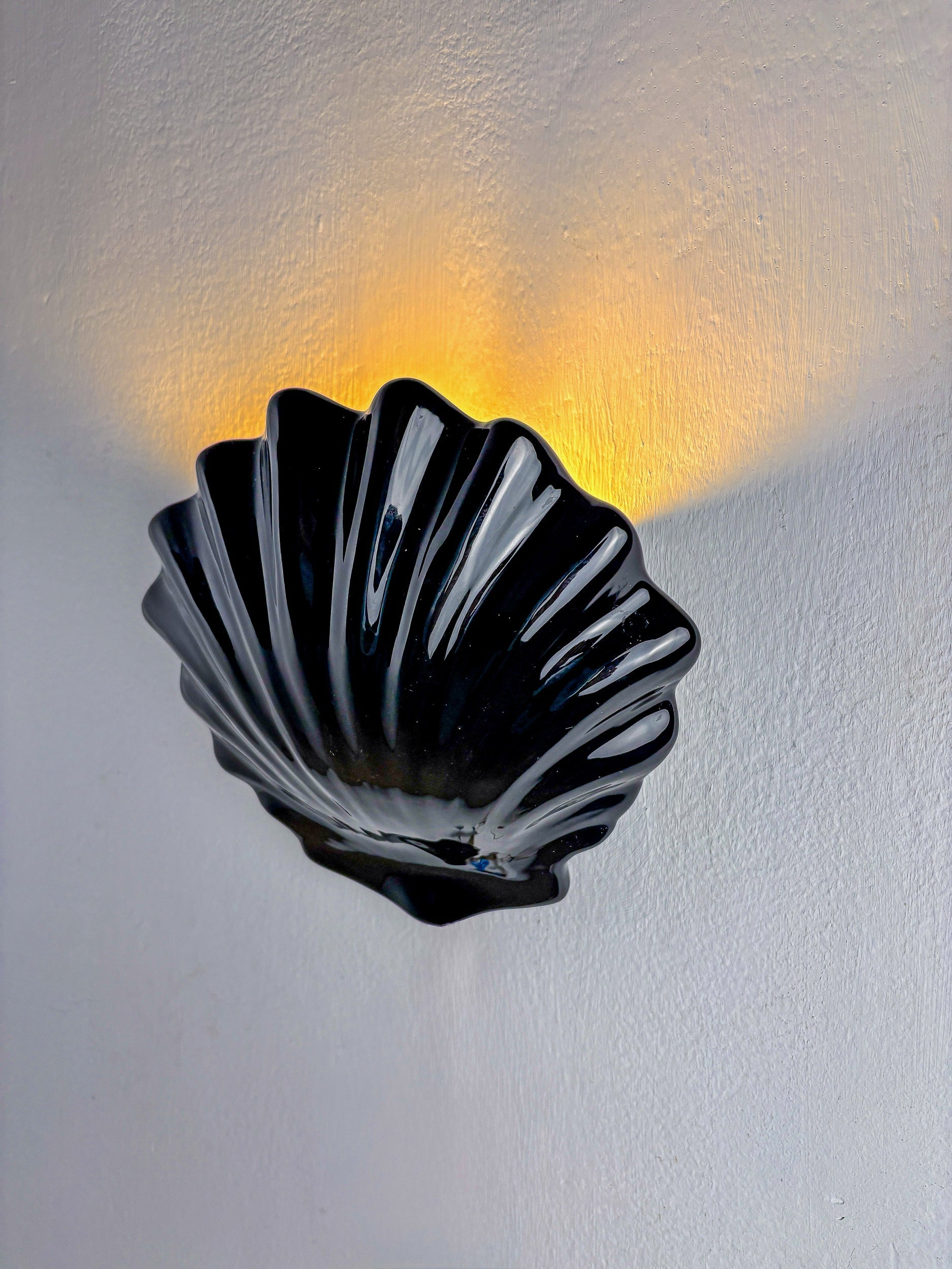 Italian shell-shaped wall sconce, black ceramic, 1970's — side angle