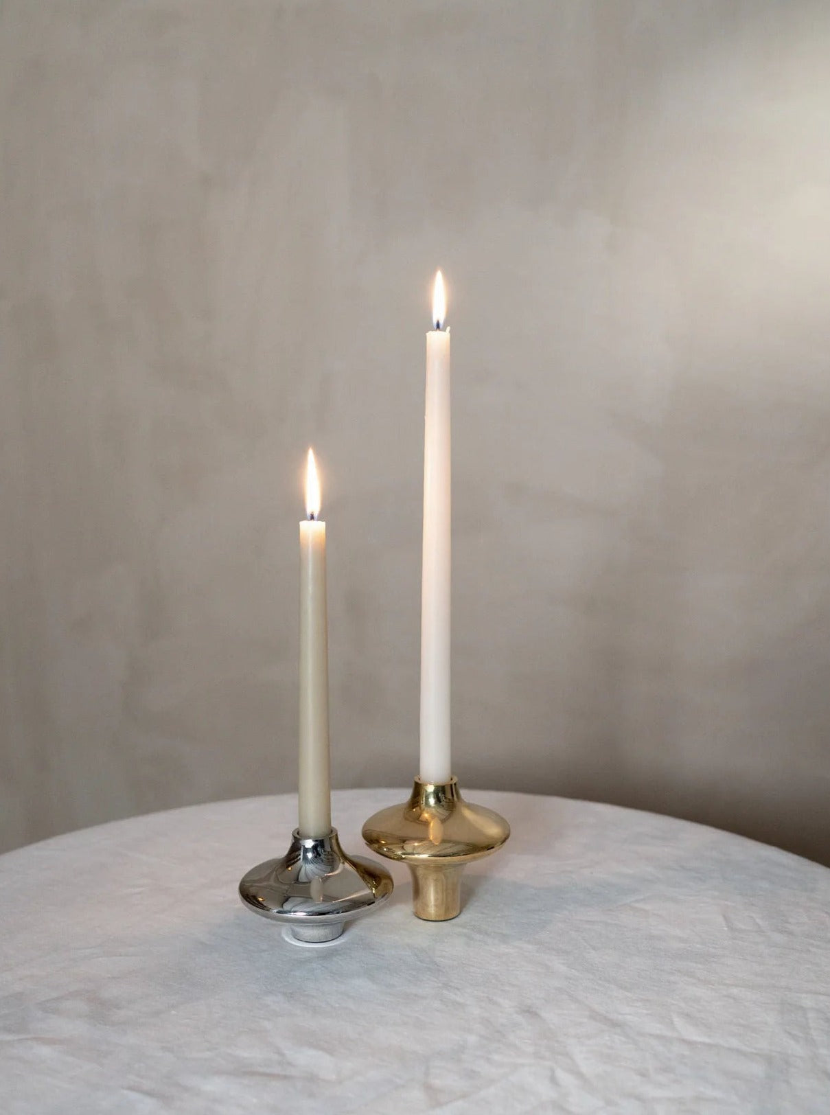 Doublet Candleholder - Large - Gold — lit candle on textured table setting