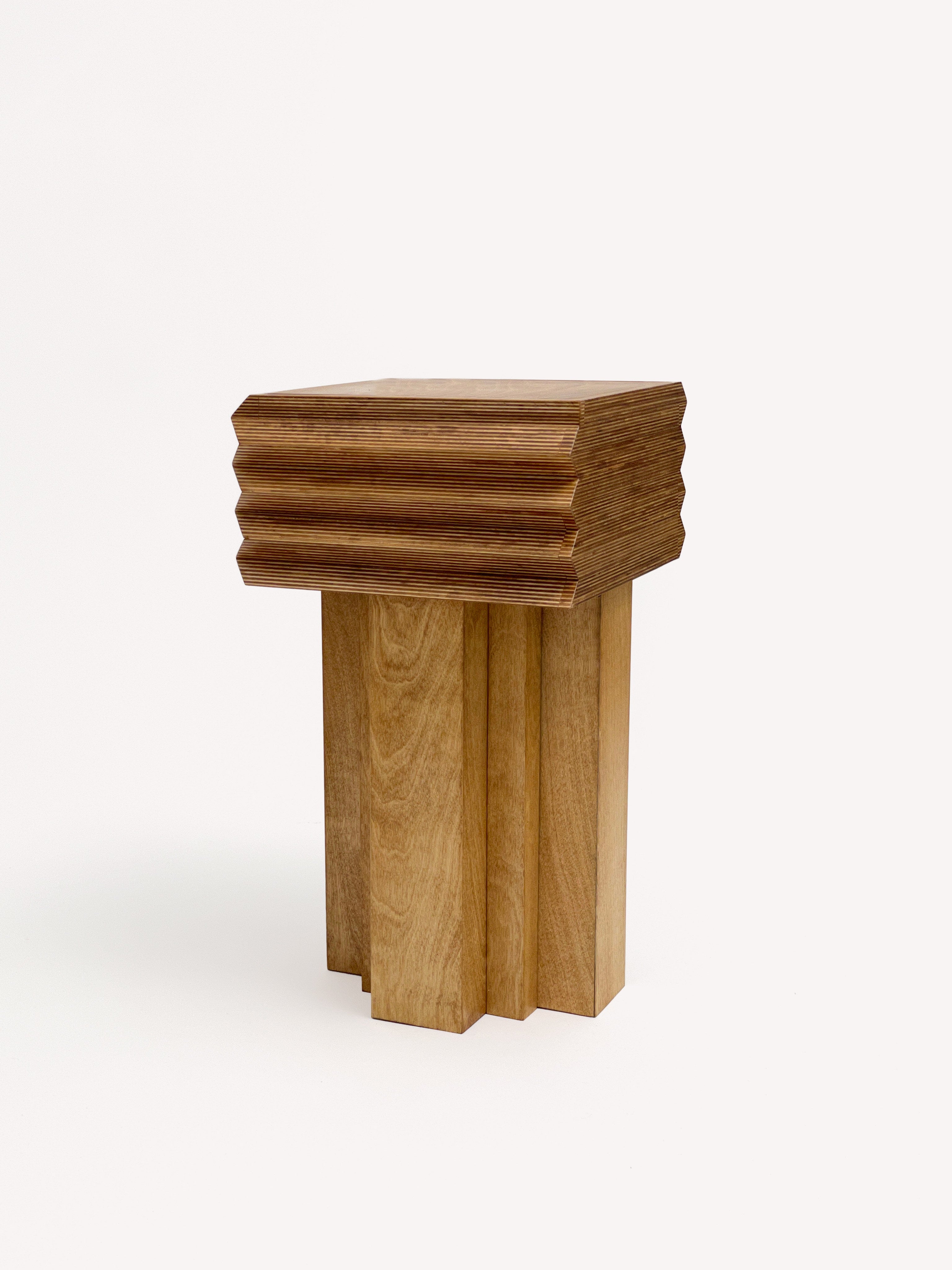 The MM Stool - Butterscotch by GOONS features a square wooden top with layered, stepped edges and block-like legs for a modern geometric look. The natural wood finish offers customizable style, showcasing the craftsmanship of GOONS.